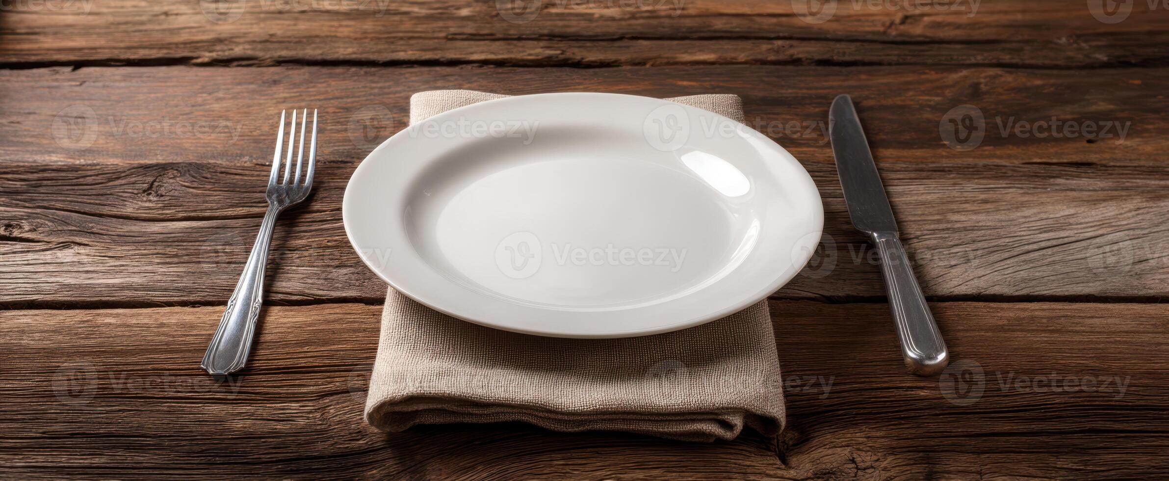 The elegant white plate beautifully arranged on a rustic wooden table. photo
