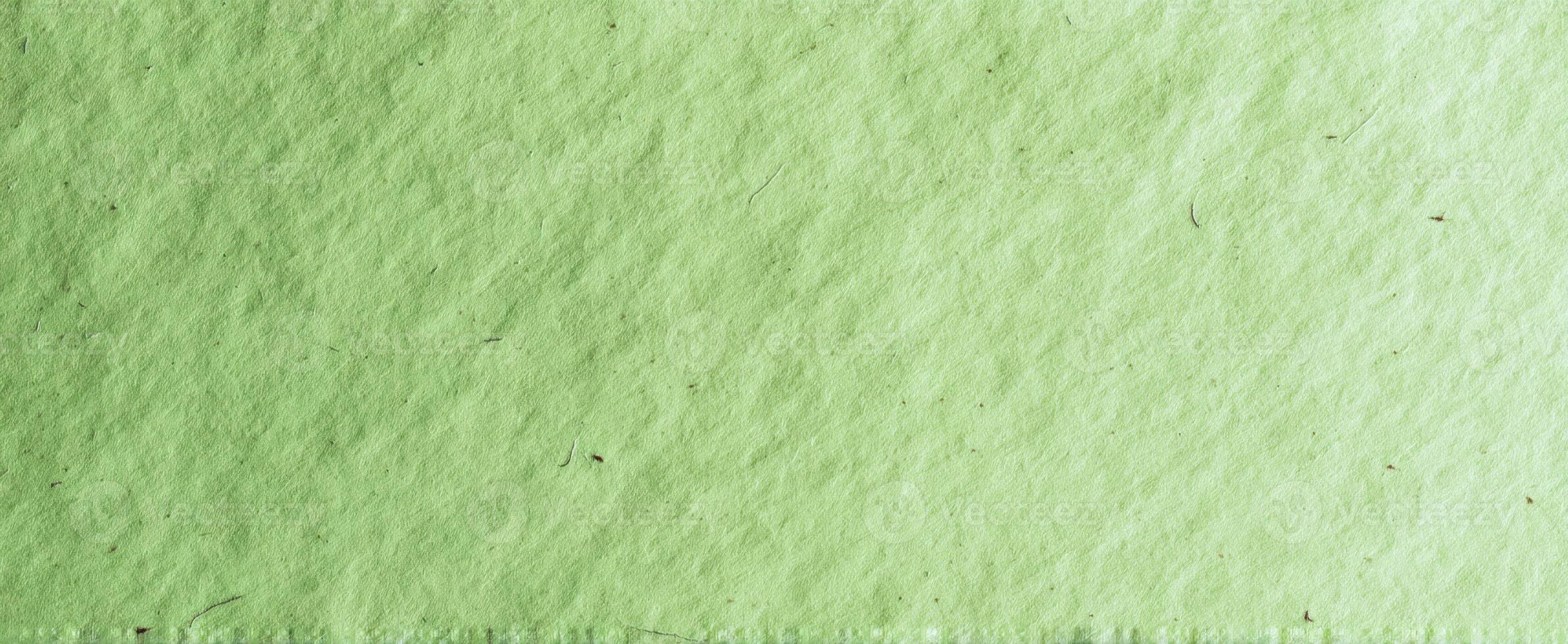 The textured green paper background creating a soothing and natural ambiance. photo