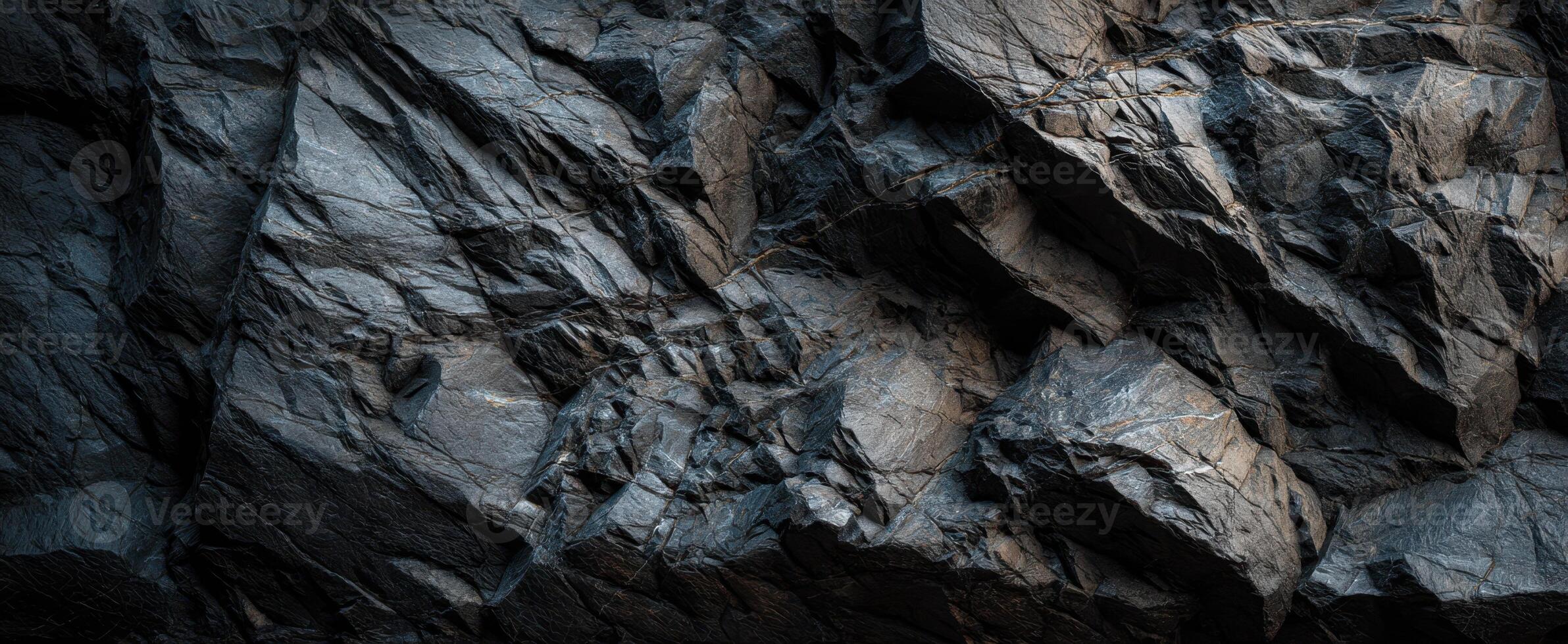 The Dark and Textured Surface of a Rocky Mountain Wall photo