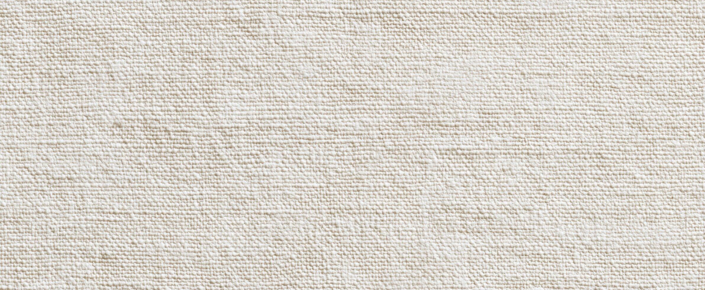The textured canvas background in a soft beige color for creative designs photo
