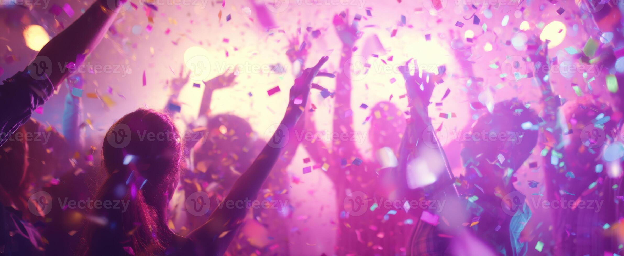 The vibrant celebration with confetti and joyful participants at a lively party. photo