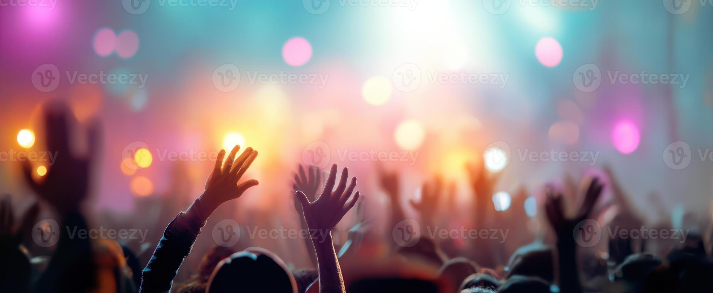 The vibrant hands of a cheering crowd at a lively music concert. photo