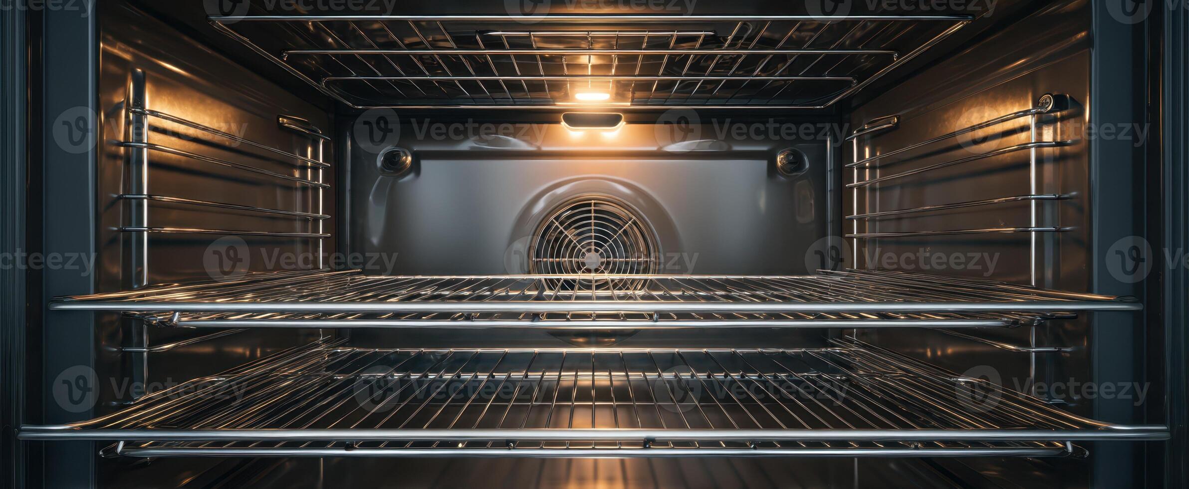The modern oven interior showcasing spacious cooking racks and warm lighting. photo