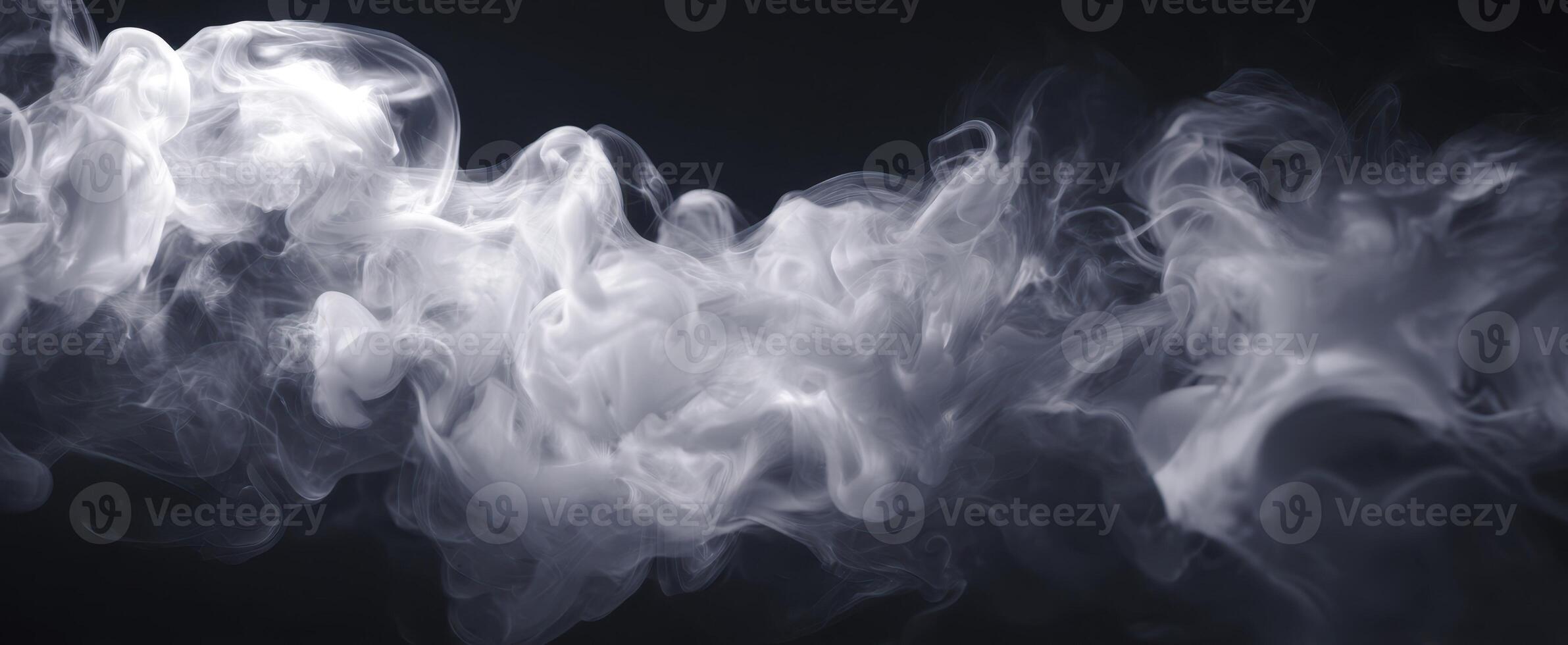 The ethereal beauty of swirling white smoke against a dark background photo