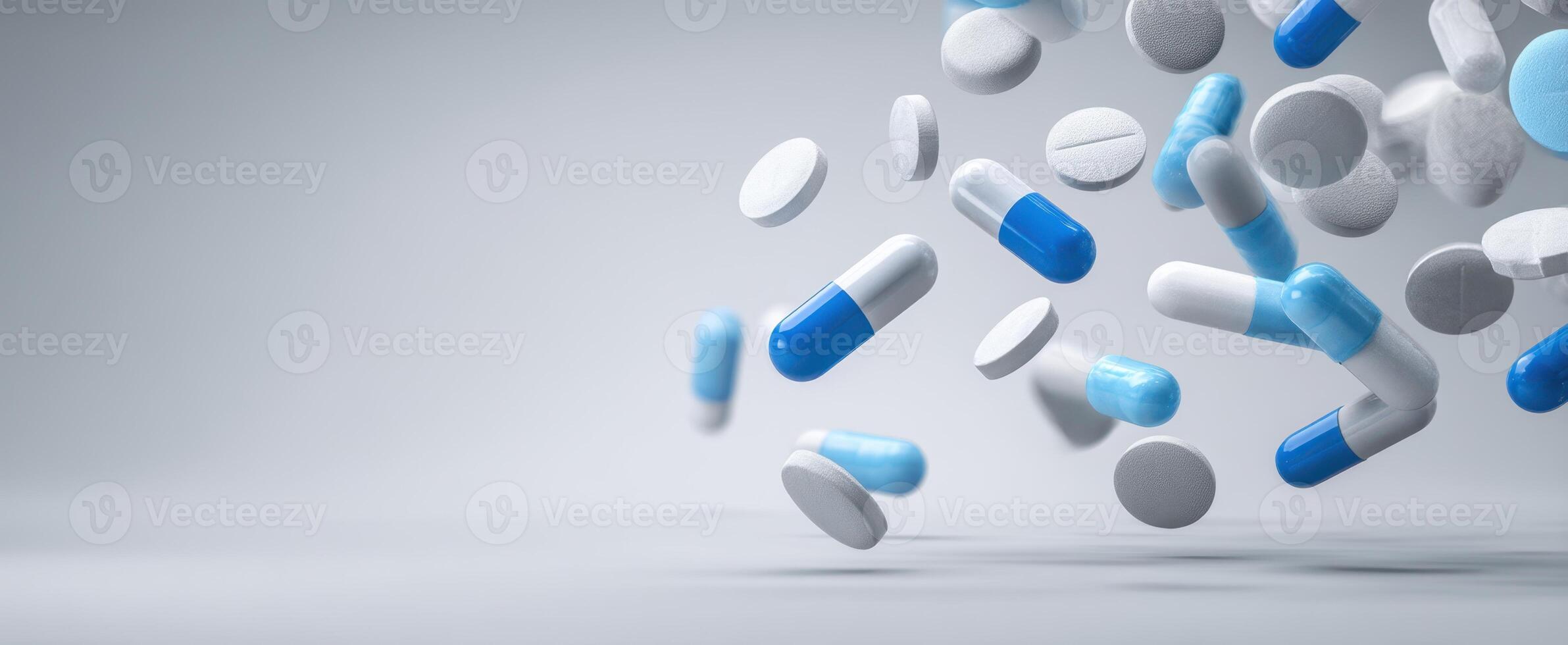 The colorful assortment of capsules and pills floating against a neutral background. photo