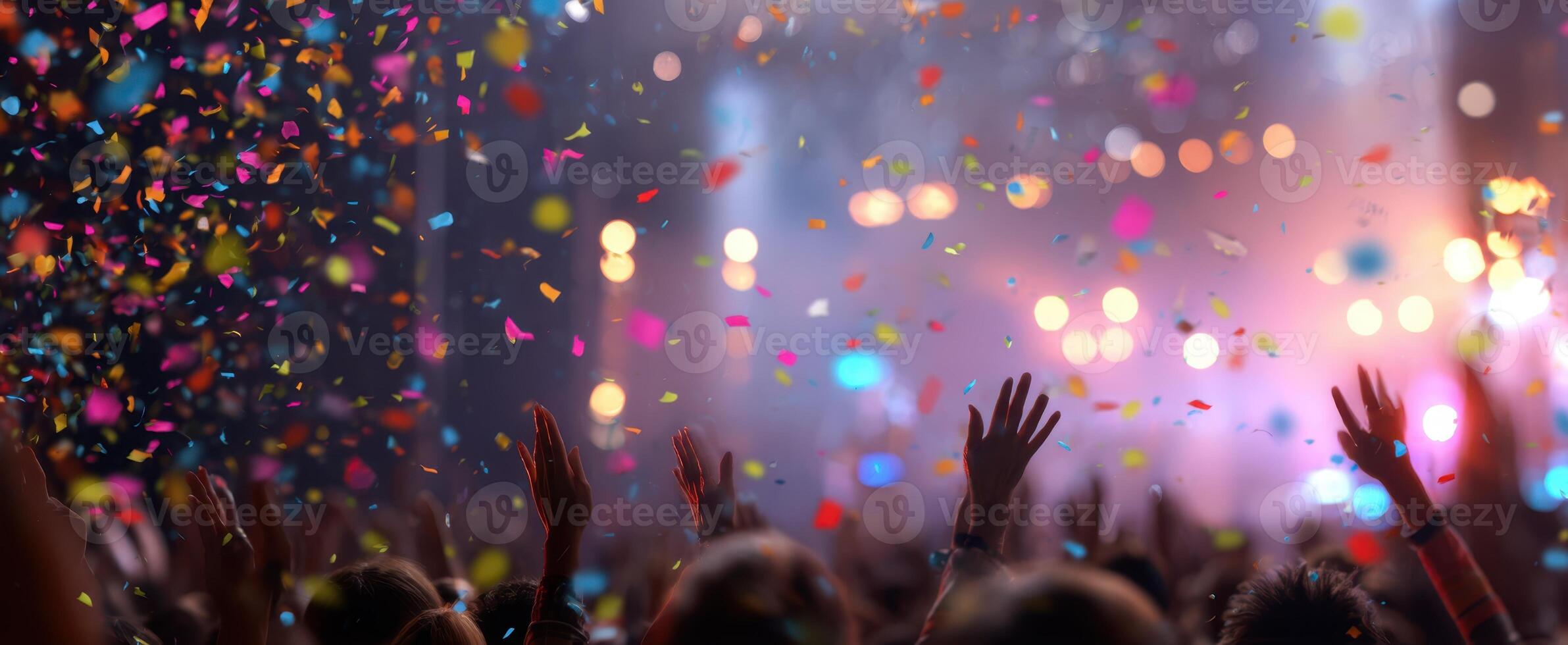 The vibrant celebration of joy with hands raised and confetti flying. photo