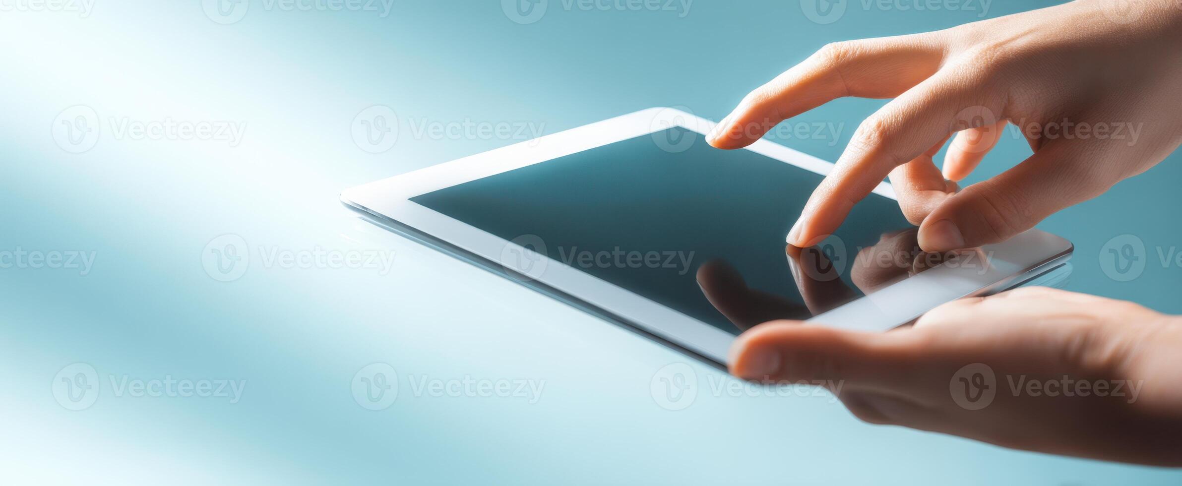 The hands interacting with a tablet device against a sleek modern background. photo