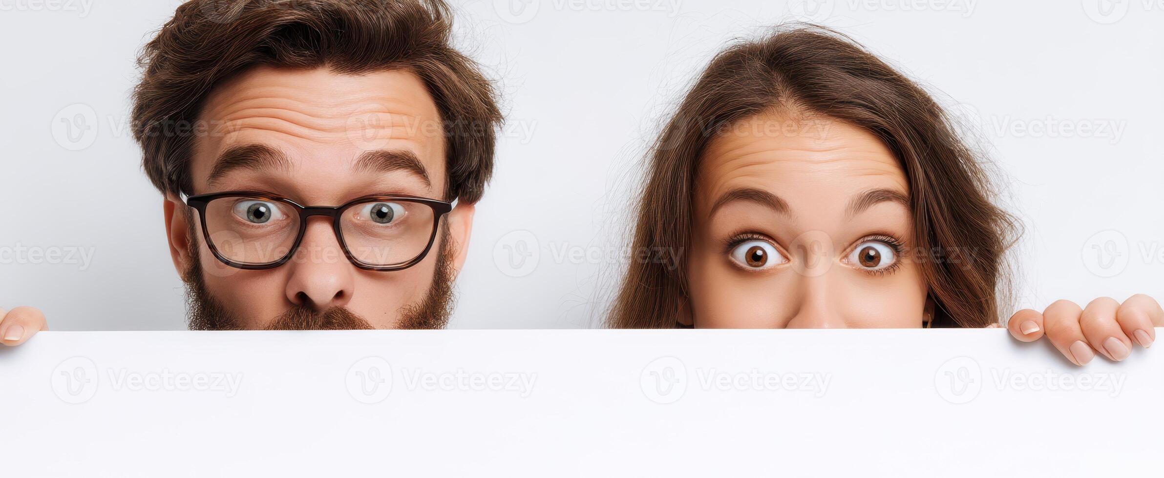 The young couple showcases their surprise with a playful expression. photo