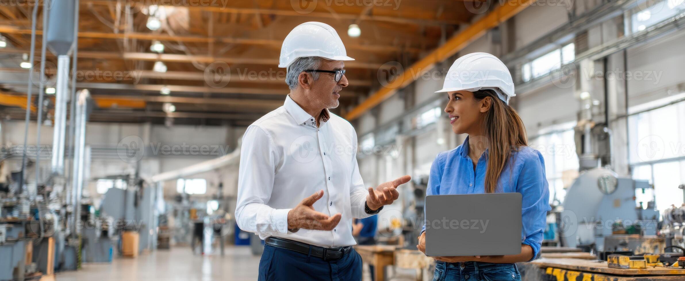 The professionals discussing project details in a modern industrial workspace. photo