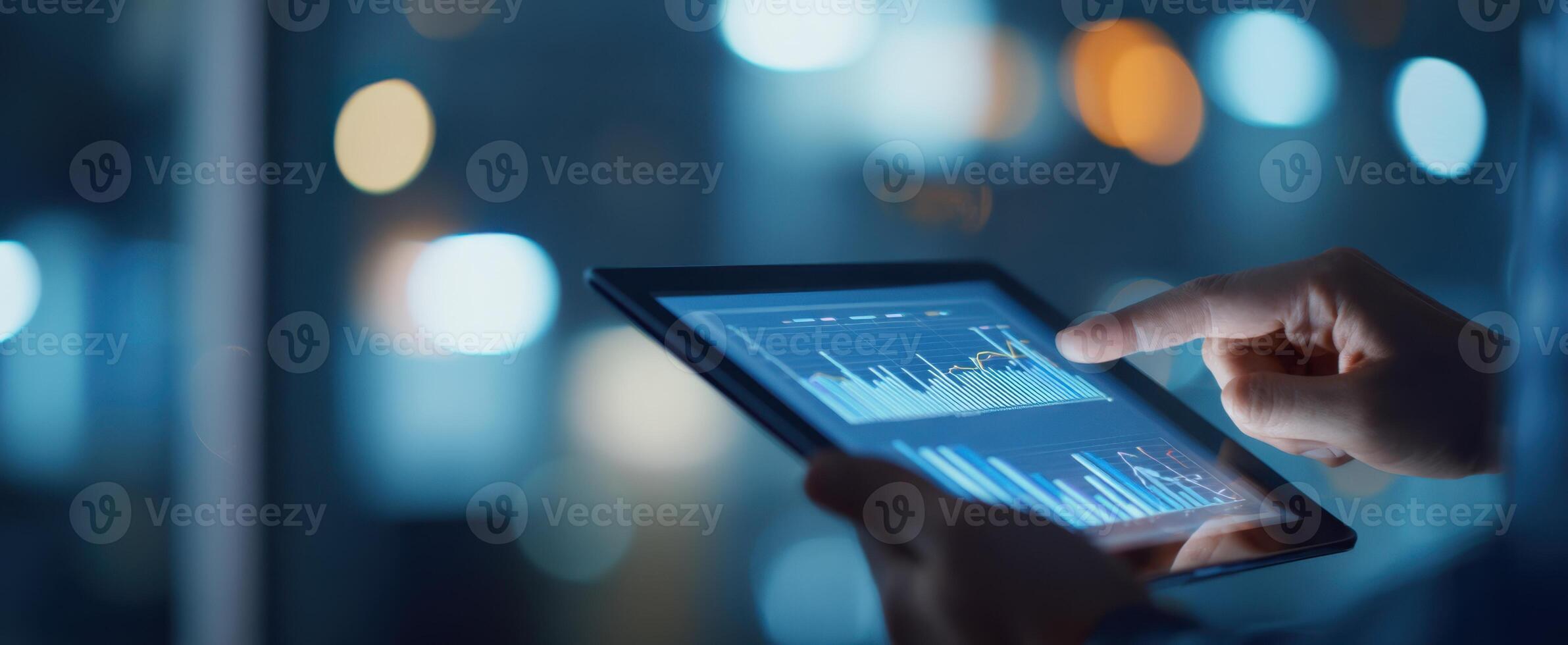 The tablet displaying financial data and graphs in a modern workspace. photo