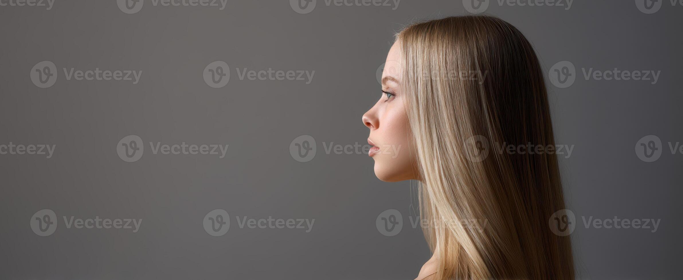The profile of a beautiful young woman with long blonde hair. photo