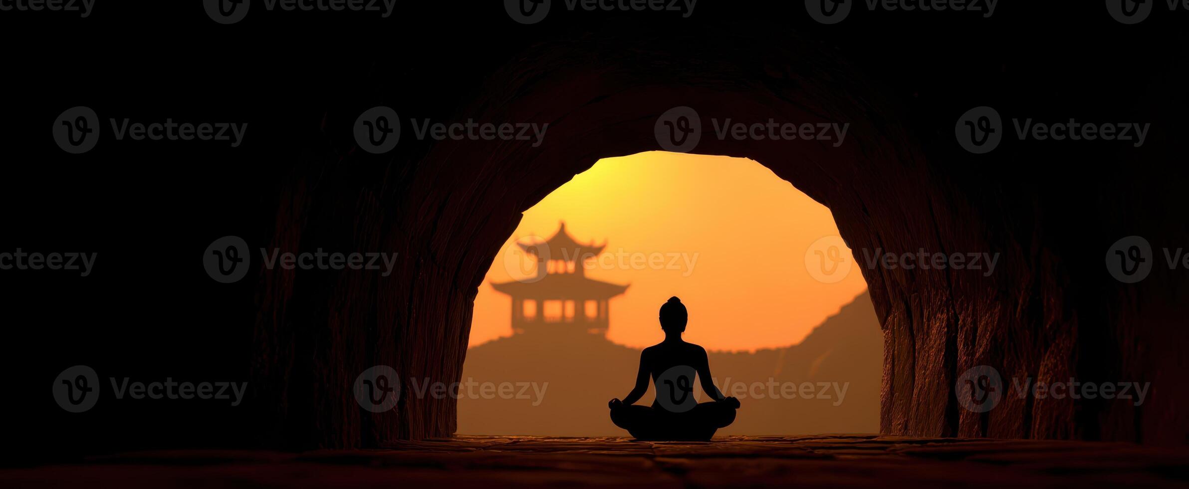 The silhouette of a meditating figure against a serene sunset backdrop. photo
