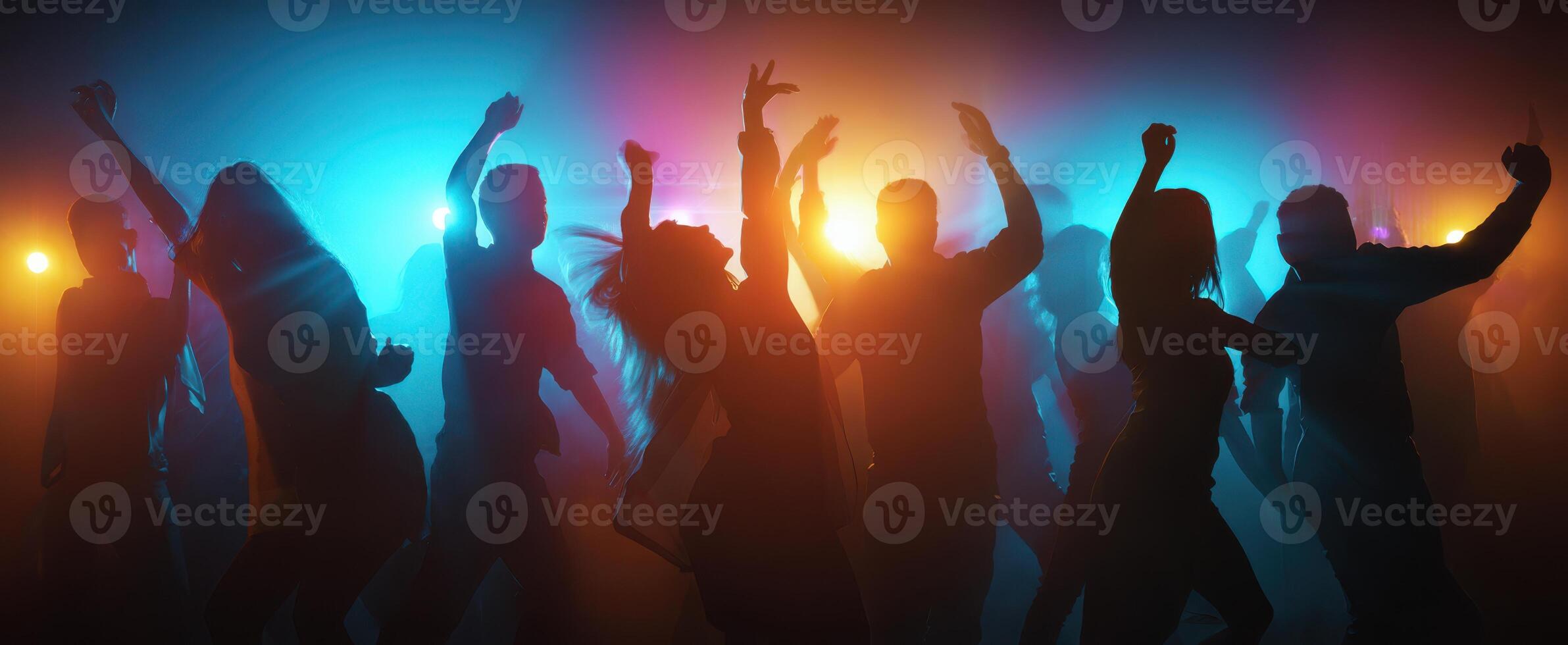 The vibrant silhouettes dancing joyfully under colorful lights at a lively party. photo