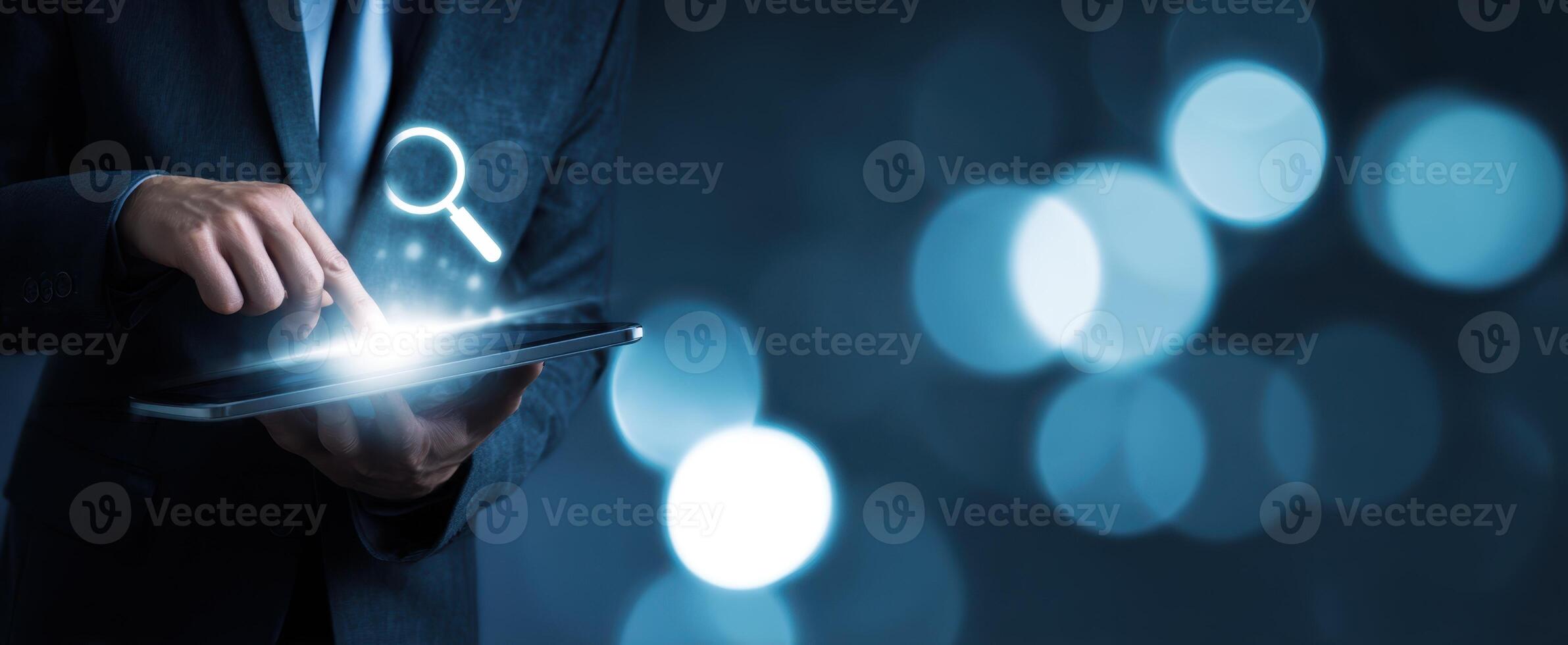 The businessman interacting with a tablet device for digital search solutions. photo