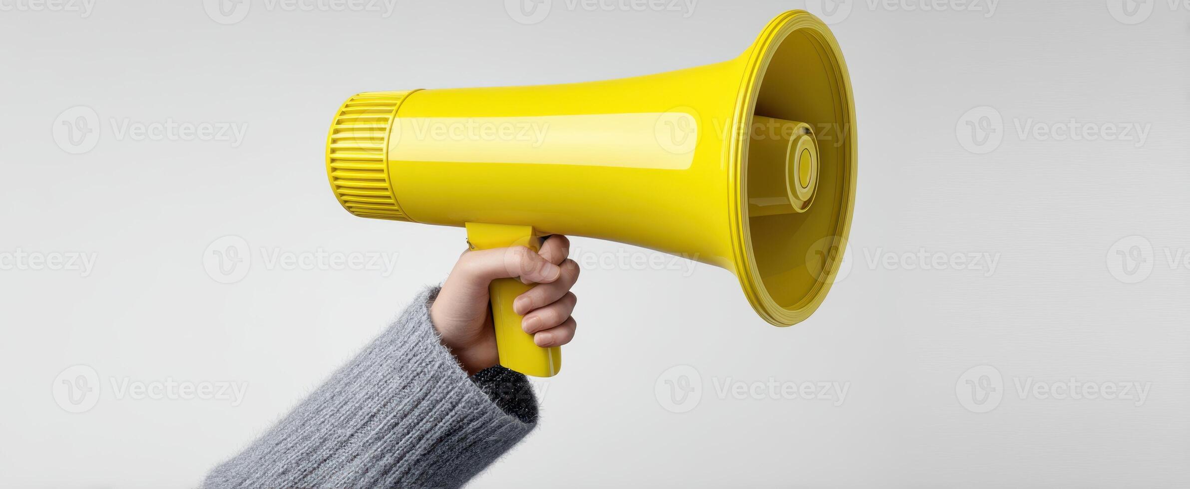The yellow megaphone held high to amplify voices and messages. photo