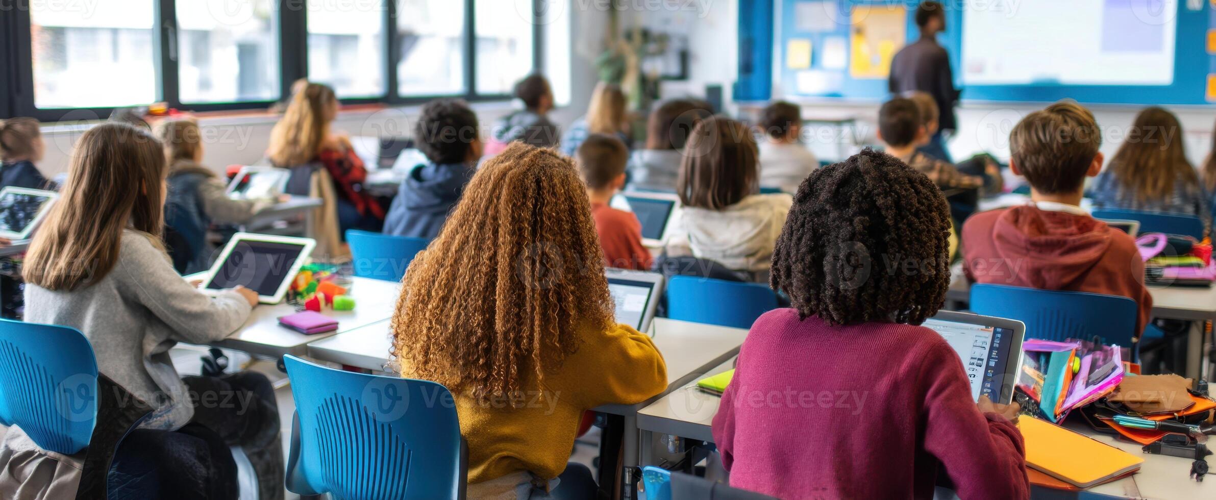 The modern classroom with students engaged in interactive learning using tablets. photo