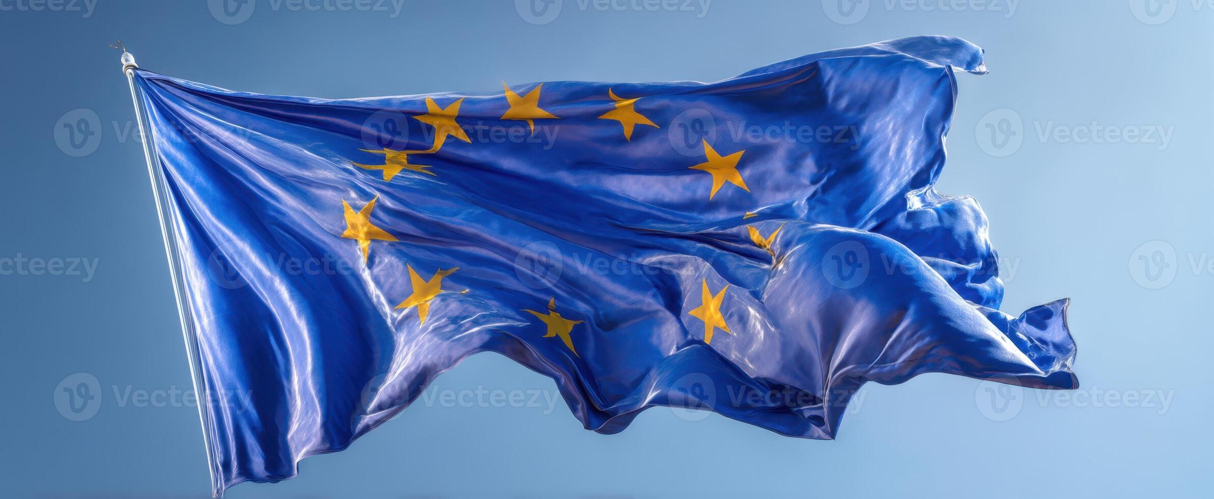 The European Union Flag Waving Gracefully Against a Sky Background photo