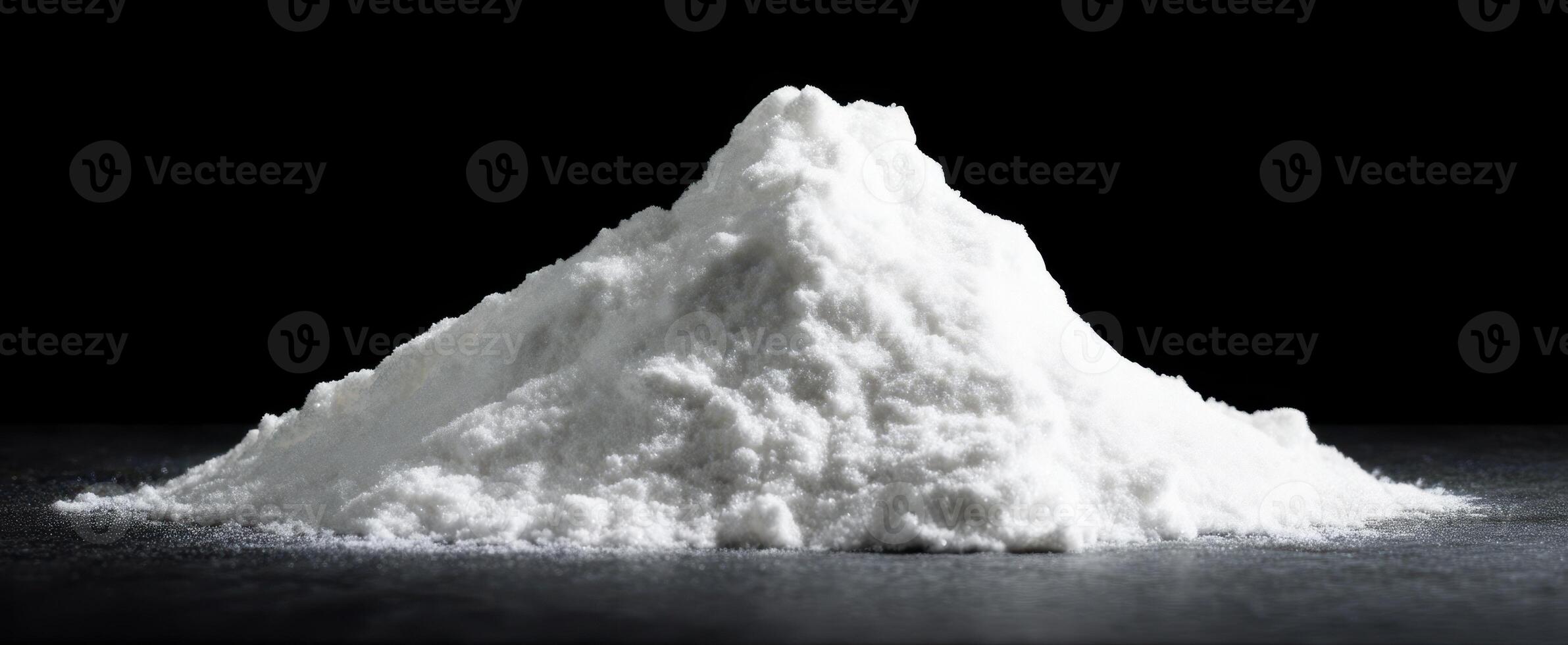 The fine white powder with a soft, fluffy texture against a dark background. photo