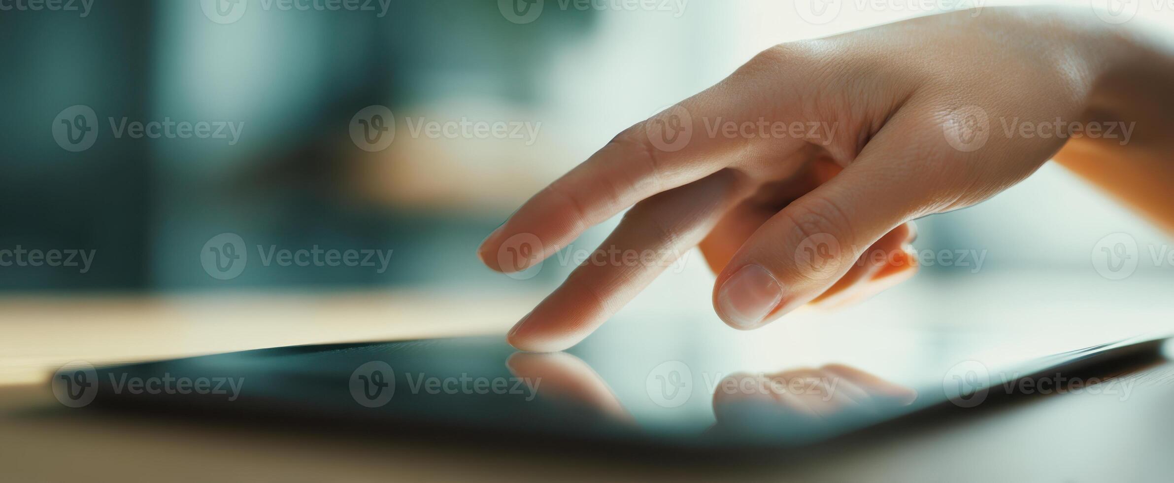 The Hand Engaging with a Touchscreen Tablet in a Modern Workspace photo