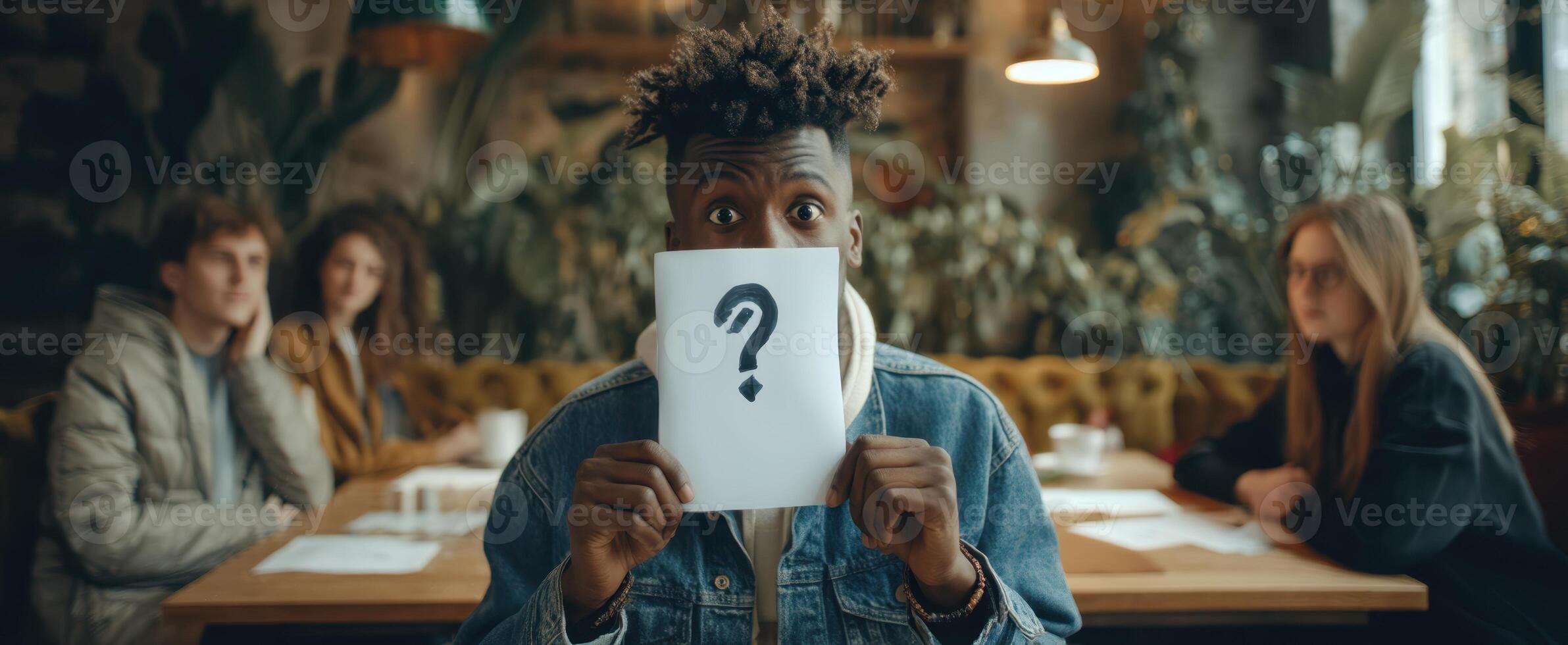 The Individual Holding a Question Mark Sign in a Thought-Provoking Situation photo