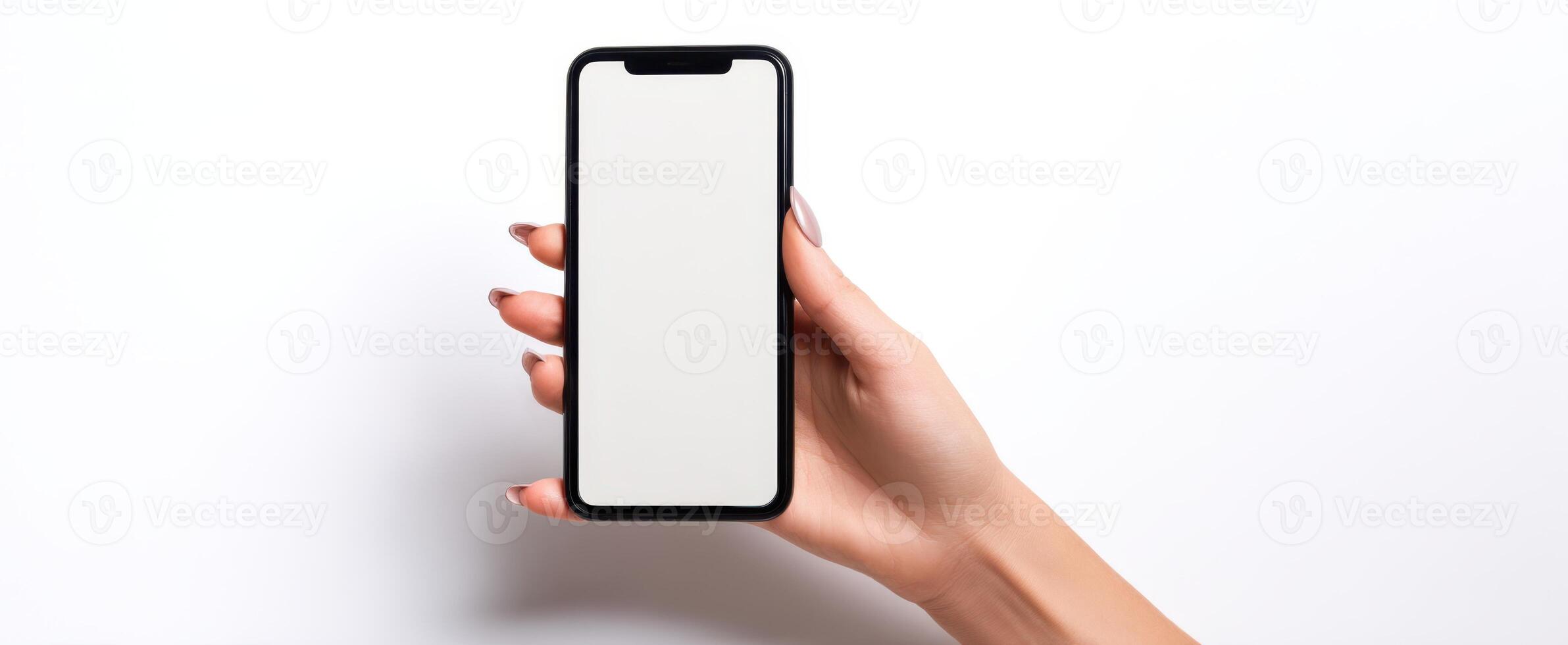The smartphone held in a hand with a blank screen for mockup purposes. photo