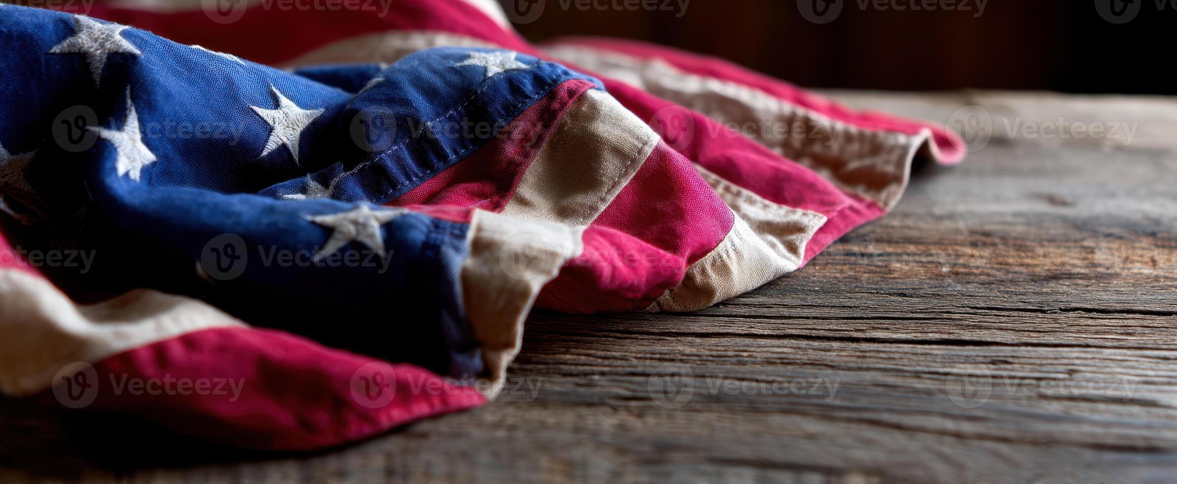The American flag elegantly draped over a rustic wooden surface. photo