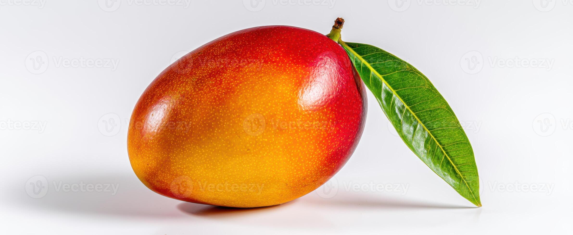The vibrant mango with a fresh green leaf on a white background photo