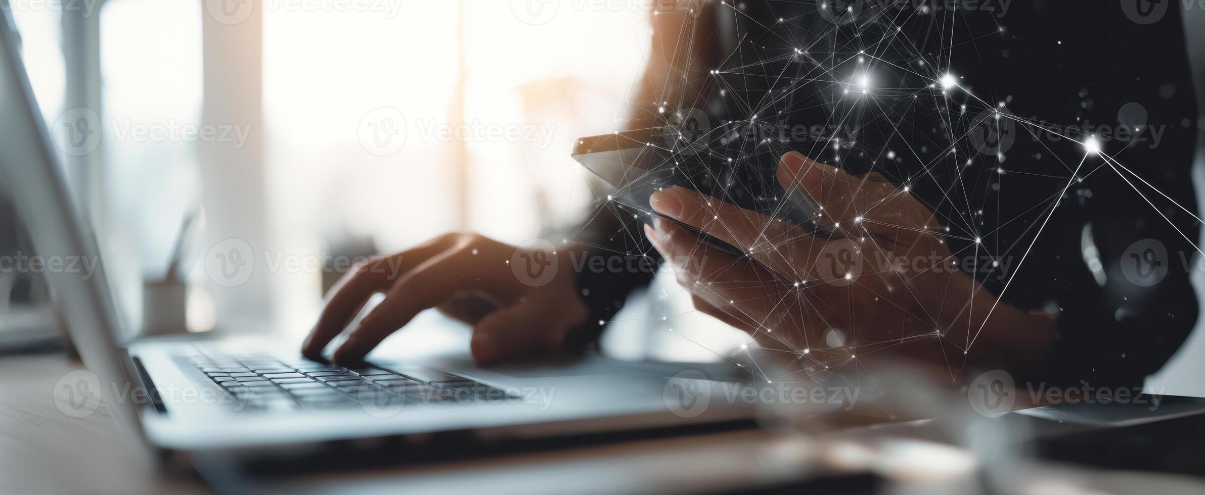 The modern professional using a laptop and smartphone in a digital workspace. photo