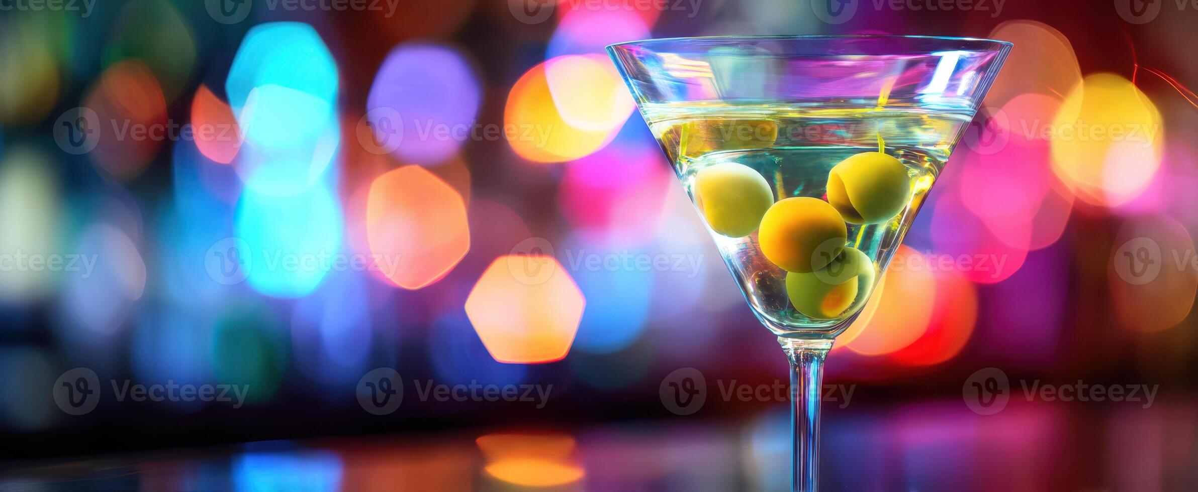 The Martini Glass Garnished with Olives Surrounded by Colorful Bokeh Lights photo