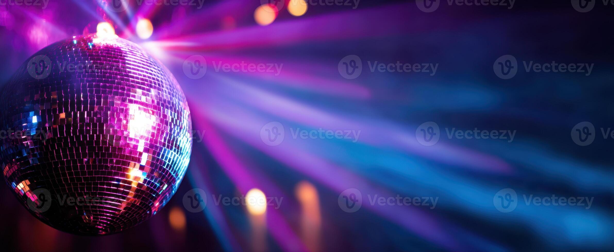 The dazzling disco ball reflecting vibrant lights at a lively party atmosphere. photo