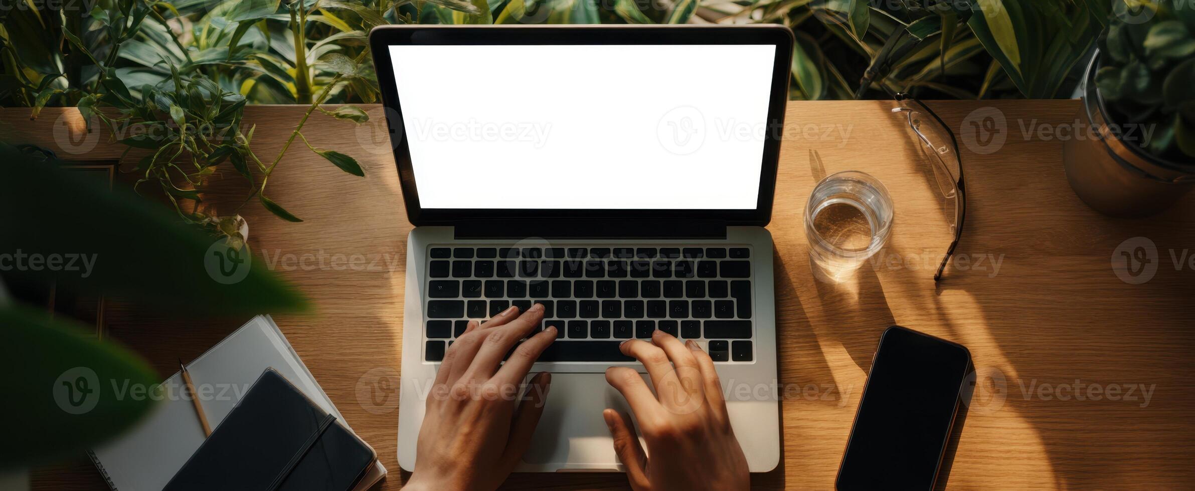 The laptop displaying a blank screen in a cozy indoor workspace. photo