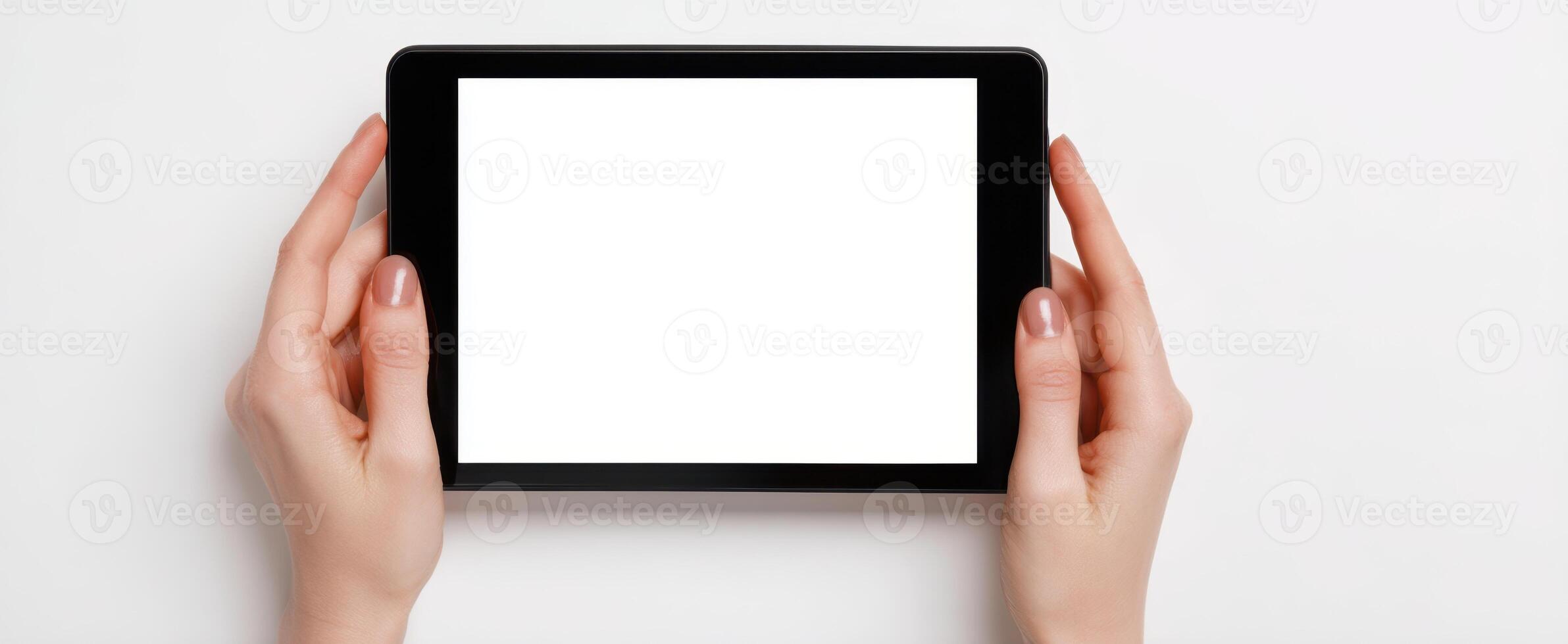 The tablet held in hands with a blank screen ready for creativity. photo