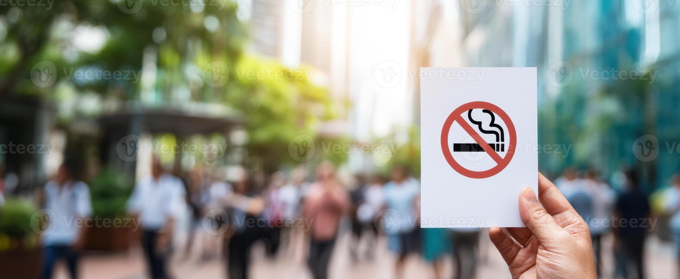 The prohibition sign against smoking held in a crowded urban environment. photo