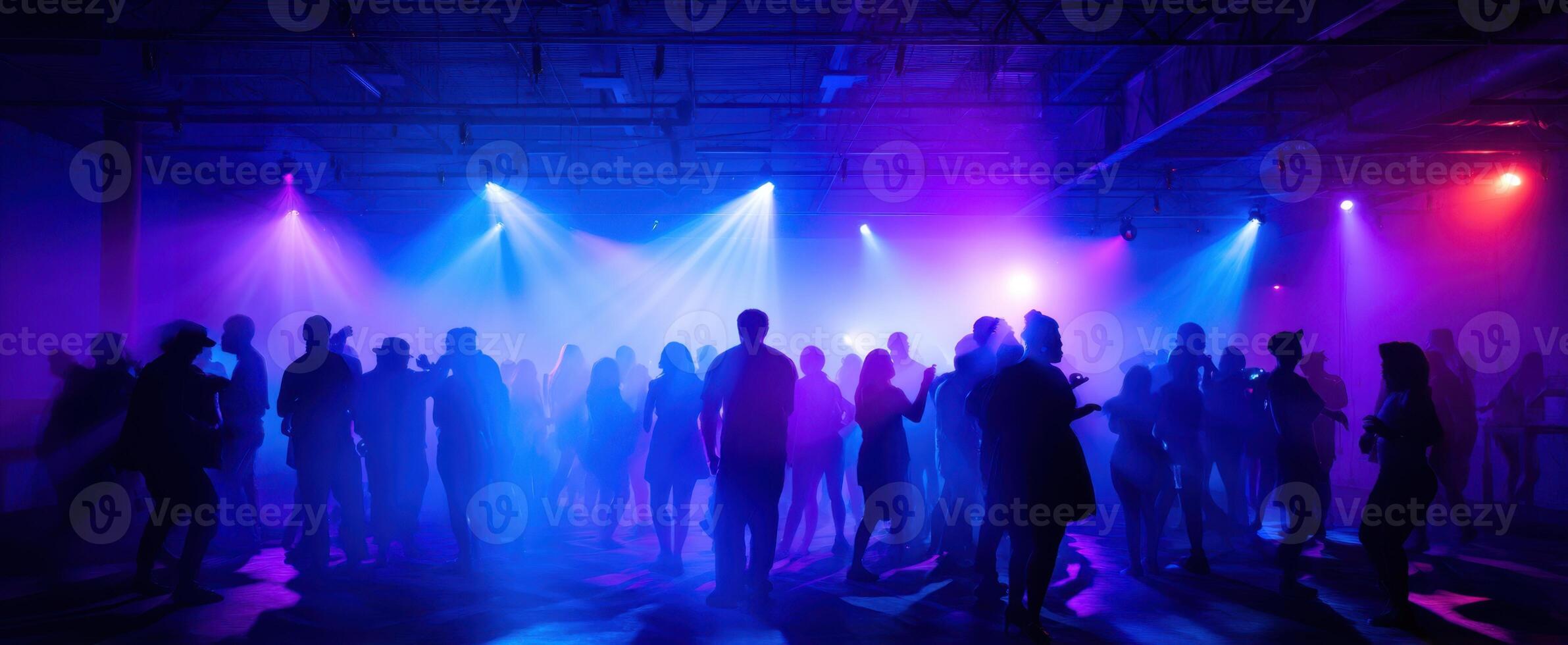 The vibrant atmosphere of a lively dance party with dynamic lighting and silhouettes. photo