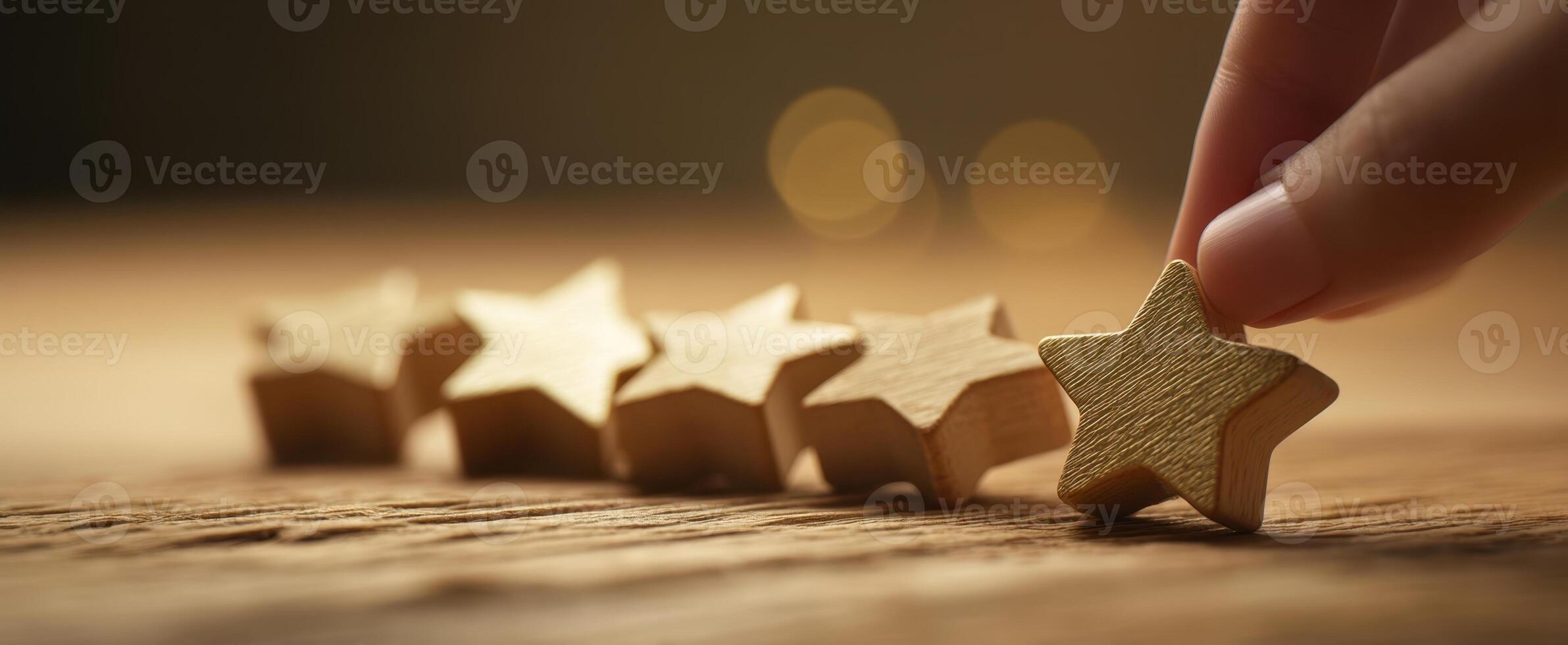 The hand selecting a wooden star from a line of decorative stars photo