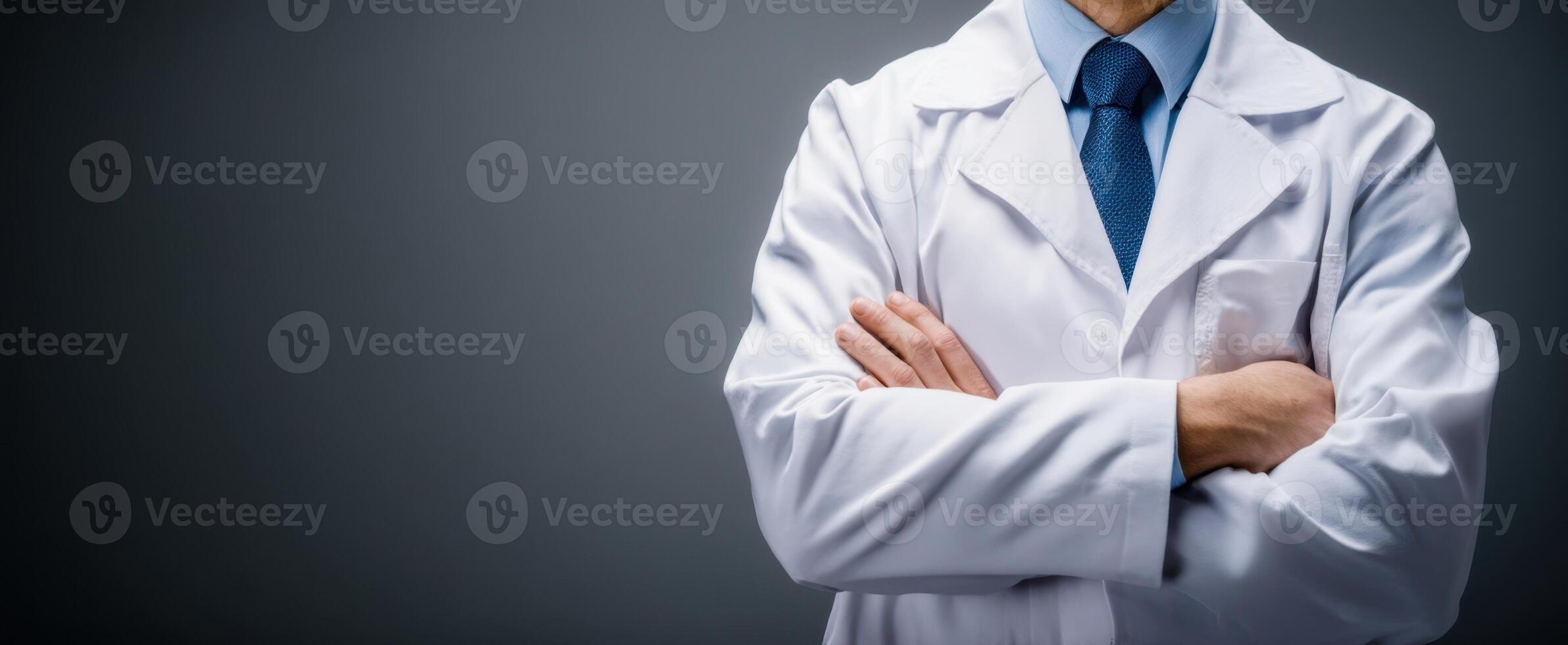 The confident doctor in a white coat with arms crossed in a professional setting photo