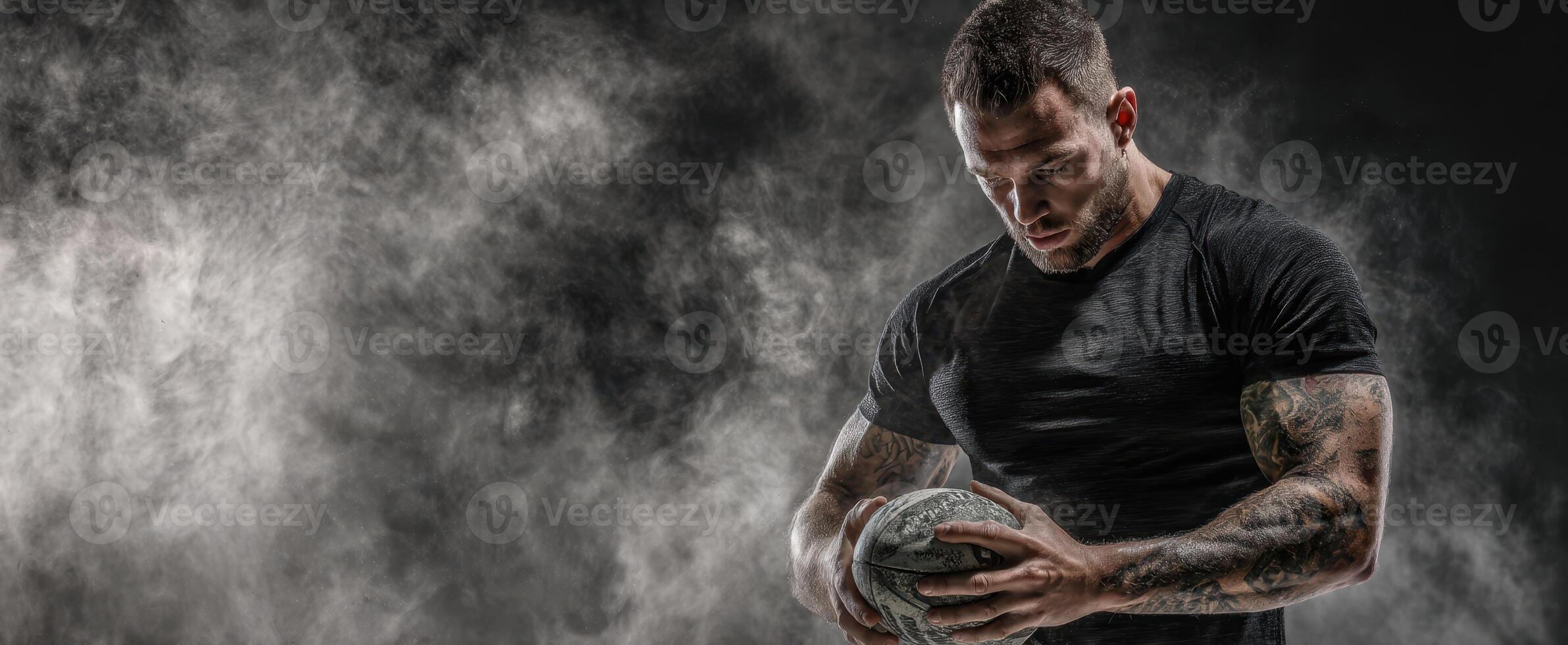 The athlete showcasing intense focus while training with a ball in a dramatic setting. photo