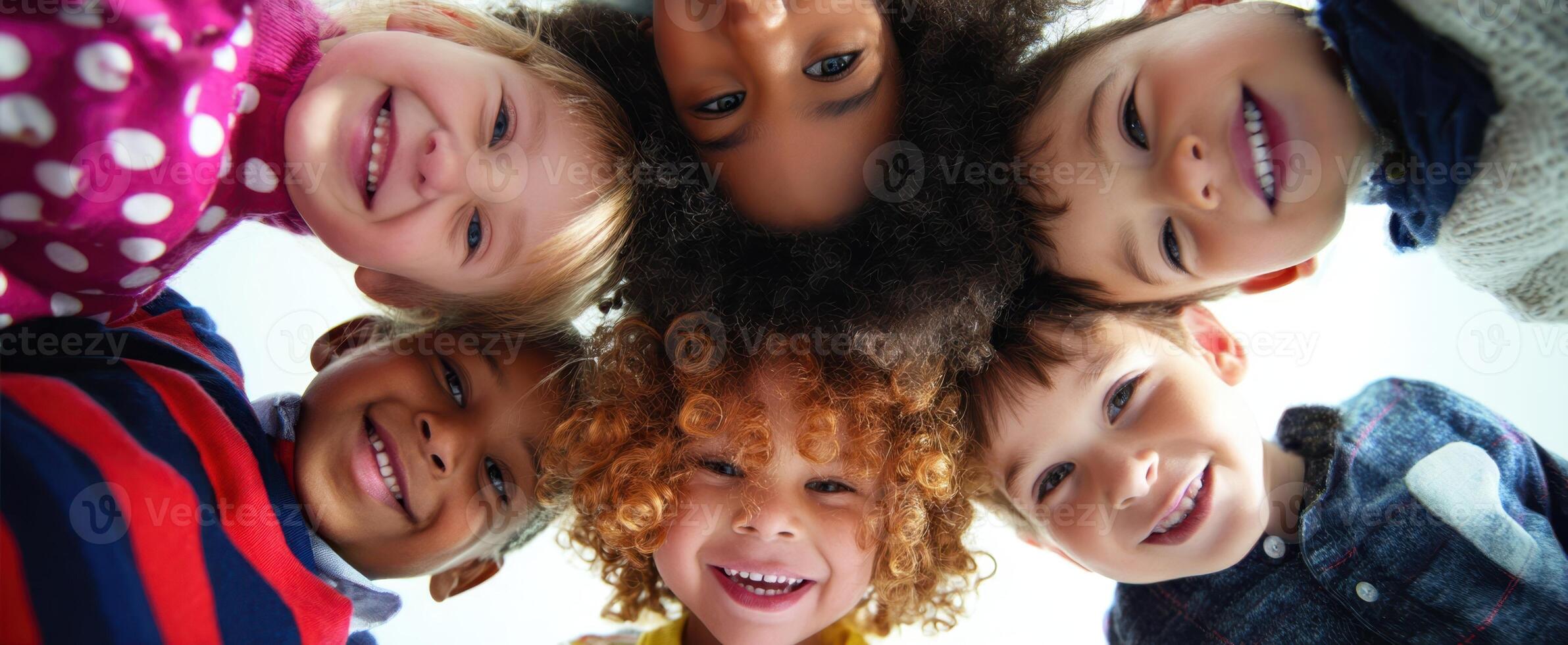 The group of cheerful children with vibrant smiles celebrating their friendship. photo