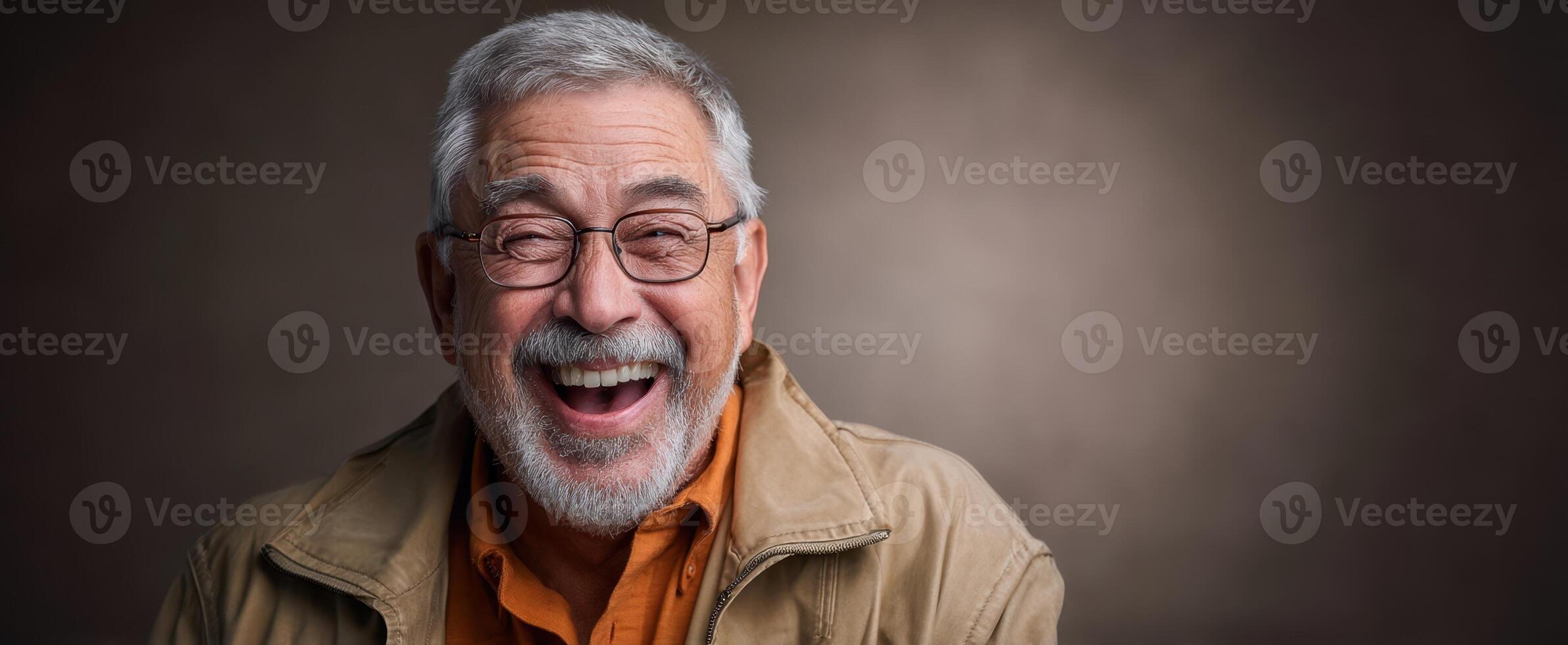 The joyful elderly man smiling broadly in a warm, inviting portrait. photo