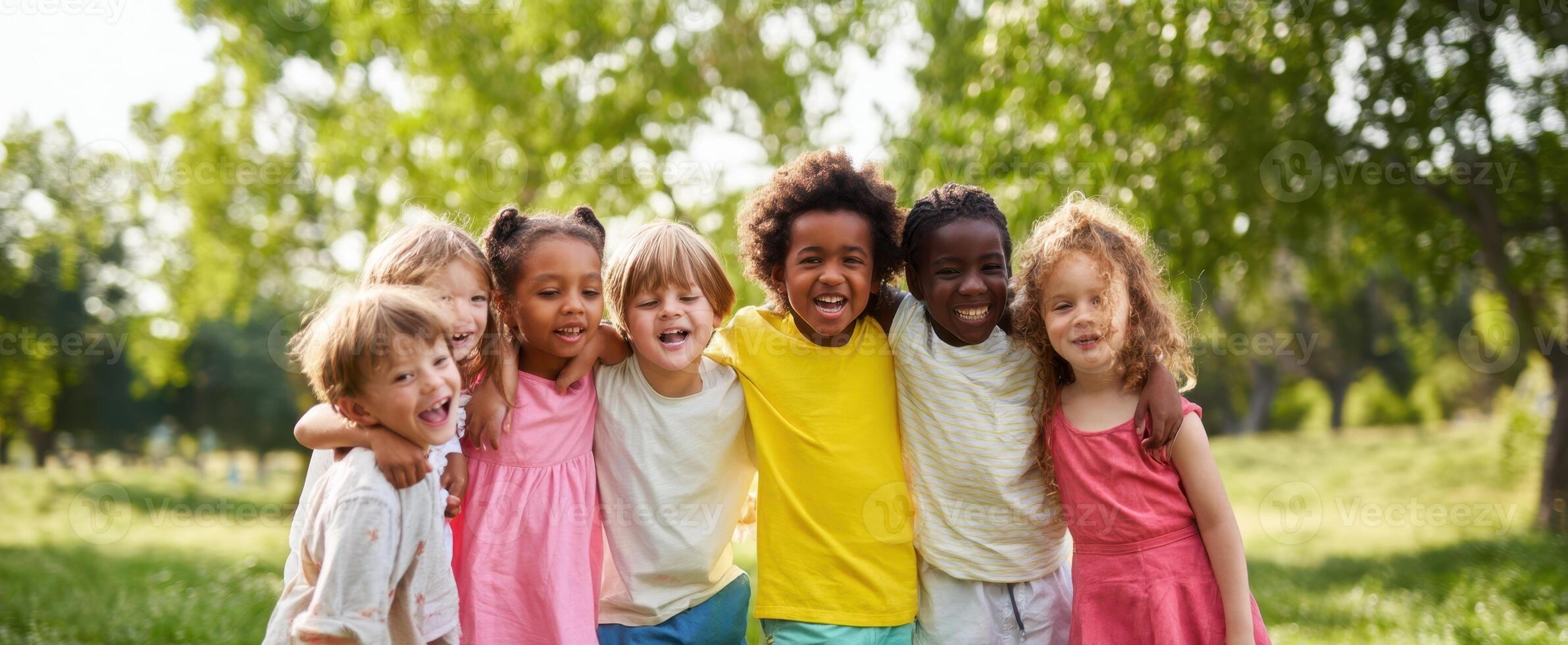 The joyful group of children playing together in a sunny park setting. photo