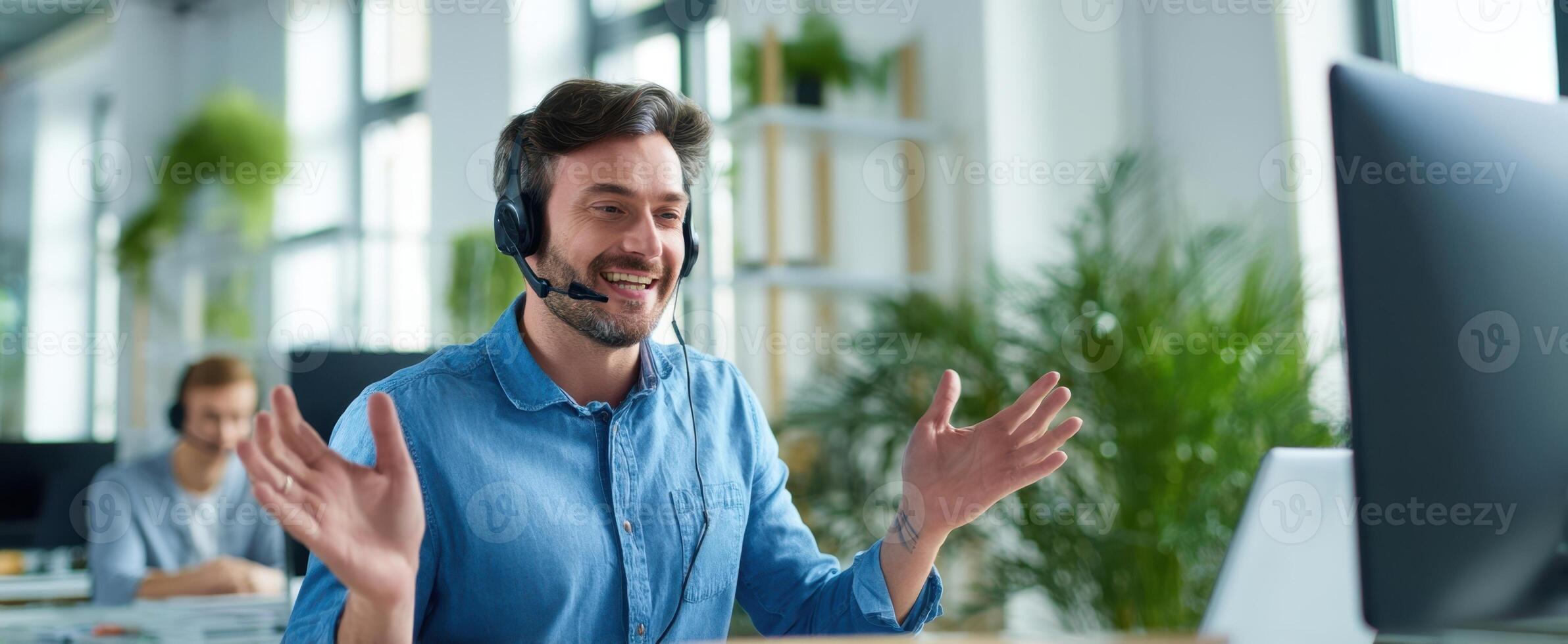 The smiling man in a headset engages in a call at work. photo