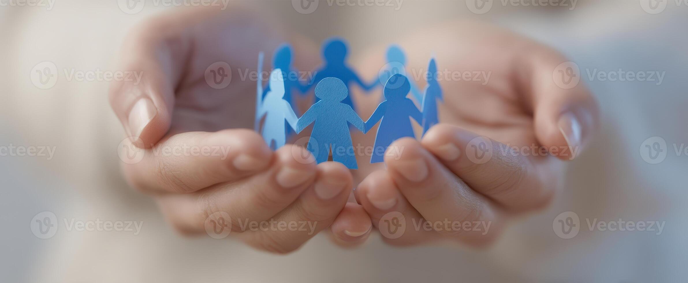 The paper figures symbolizing unity and support in compassionate hands. photo