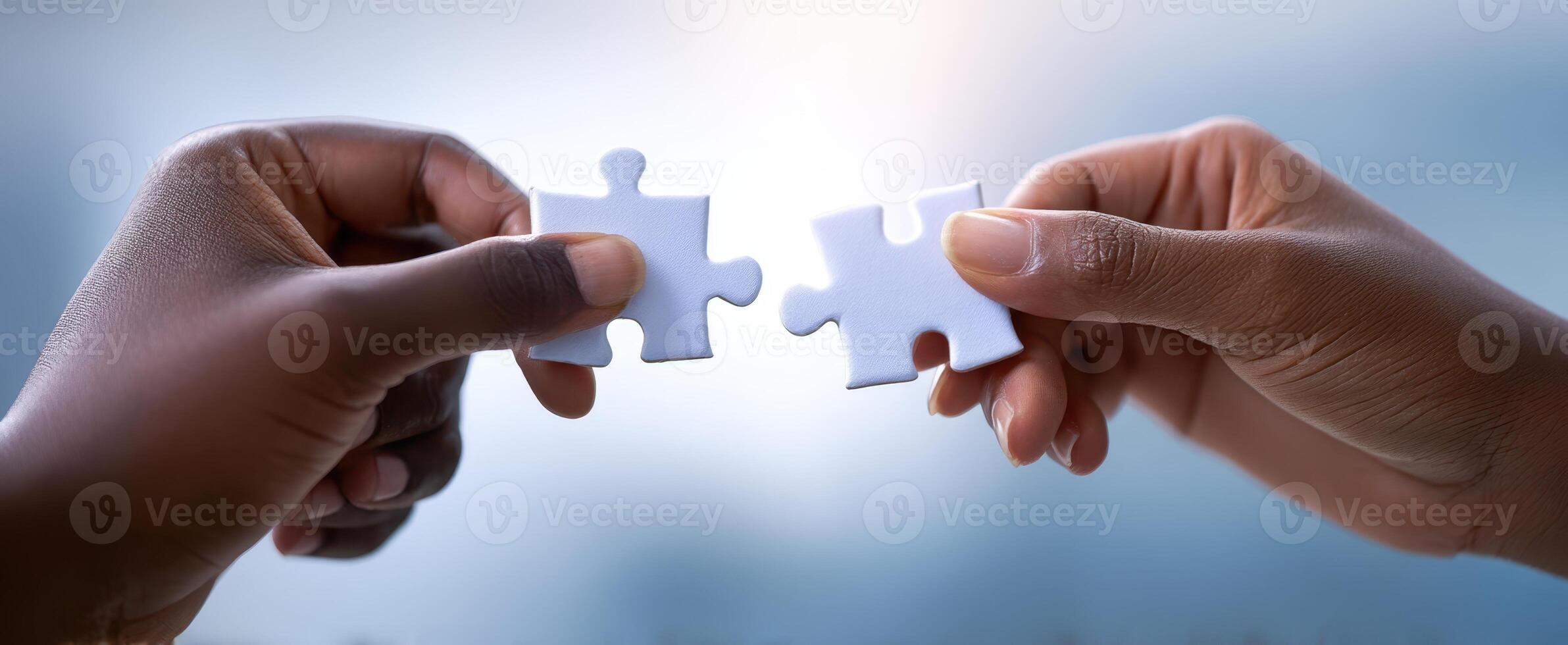 The Hands Connecting Puzzle Pieces to Symbolize Partnership and Unity photo
