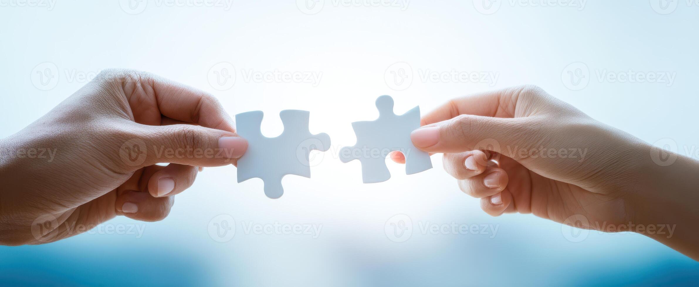 The Hands Connecting Puzzle Pieces Symbolizing Collaboration and Unity photo