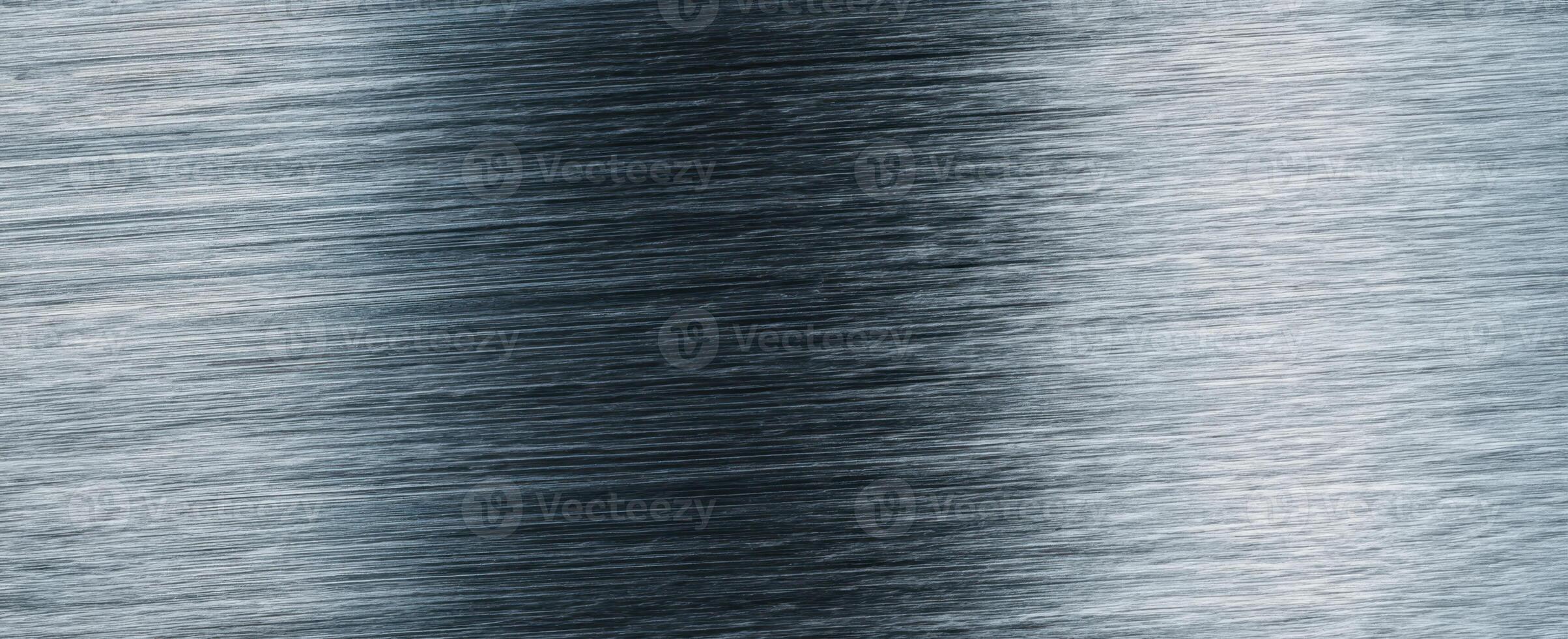 The sleek brushed metal surface showcasing intricate texture and reflections. photo