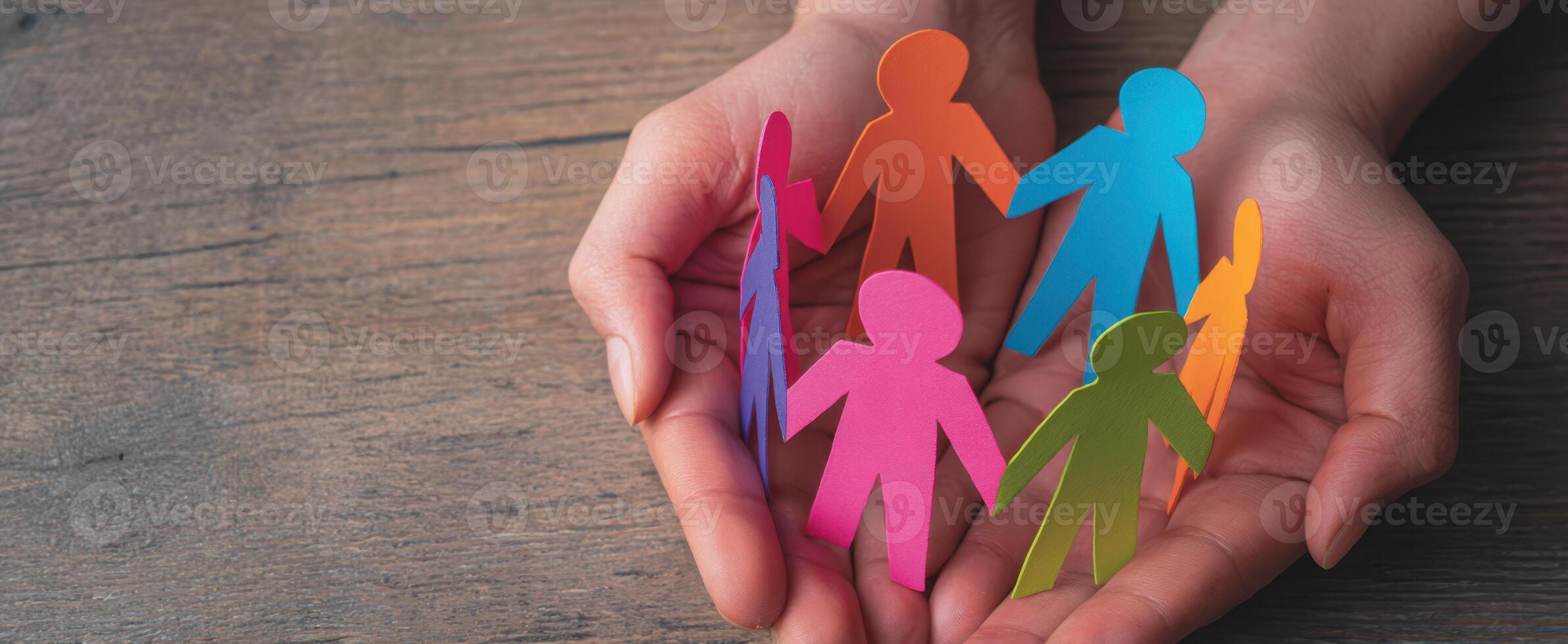 The Hands Holding Colorful Paper Figures Symbolizing Community and Togetherness photo