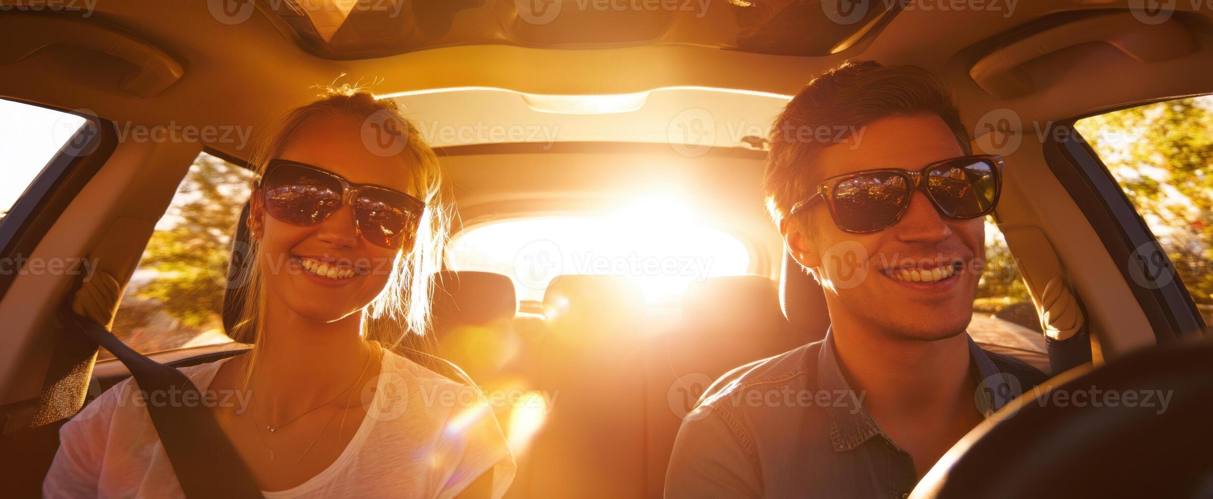 The joyful couple enjoying a sunlit drive in a car together. photo
