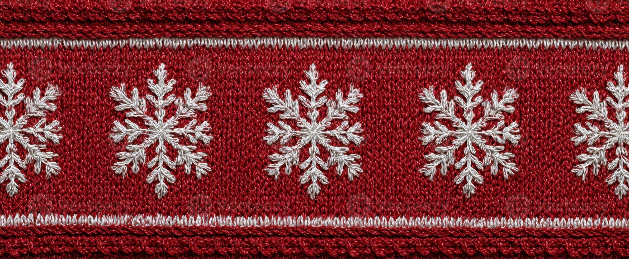 The intricate embroidery of snowflakes on a festive red background. photo
