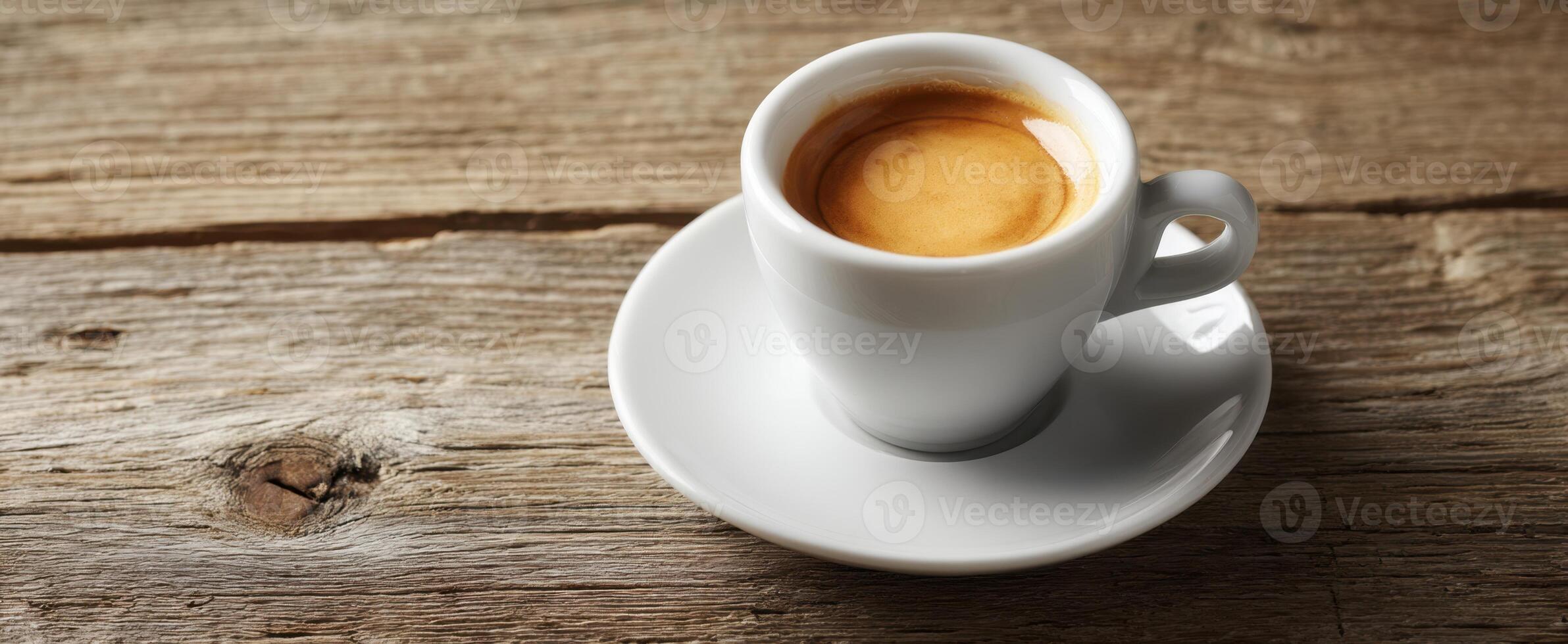 The espresso cup sitting on a rustic wooden table inviting warmth and comfort. photo