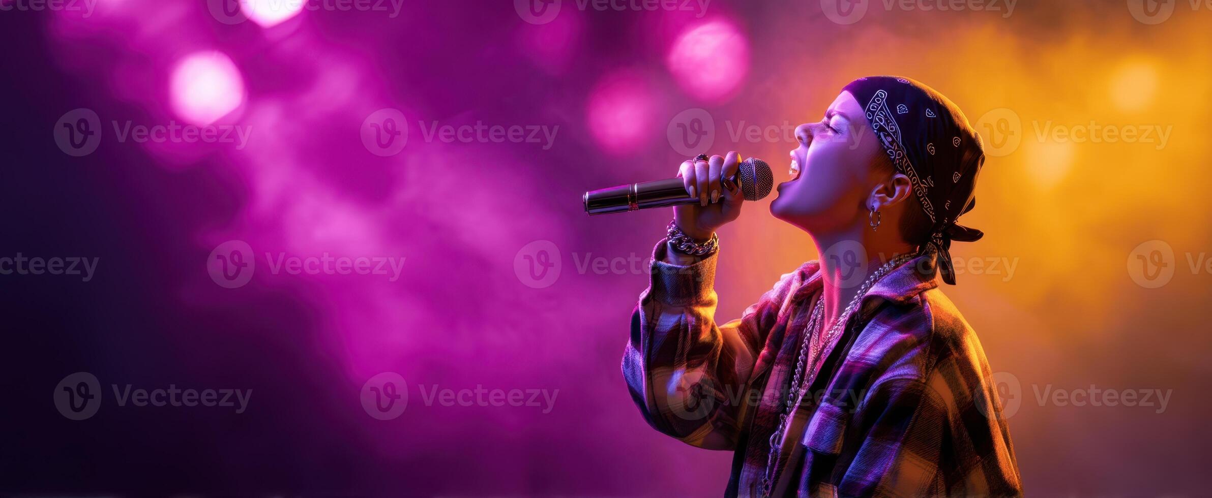 The singer passionately performing on stage under vibrant concert lights photo